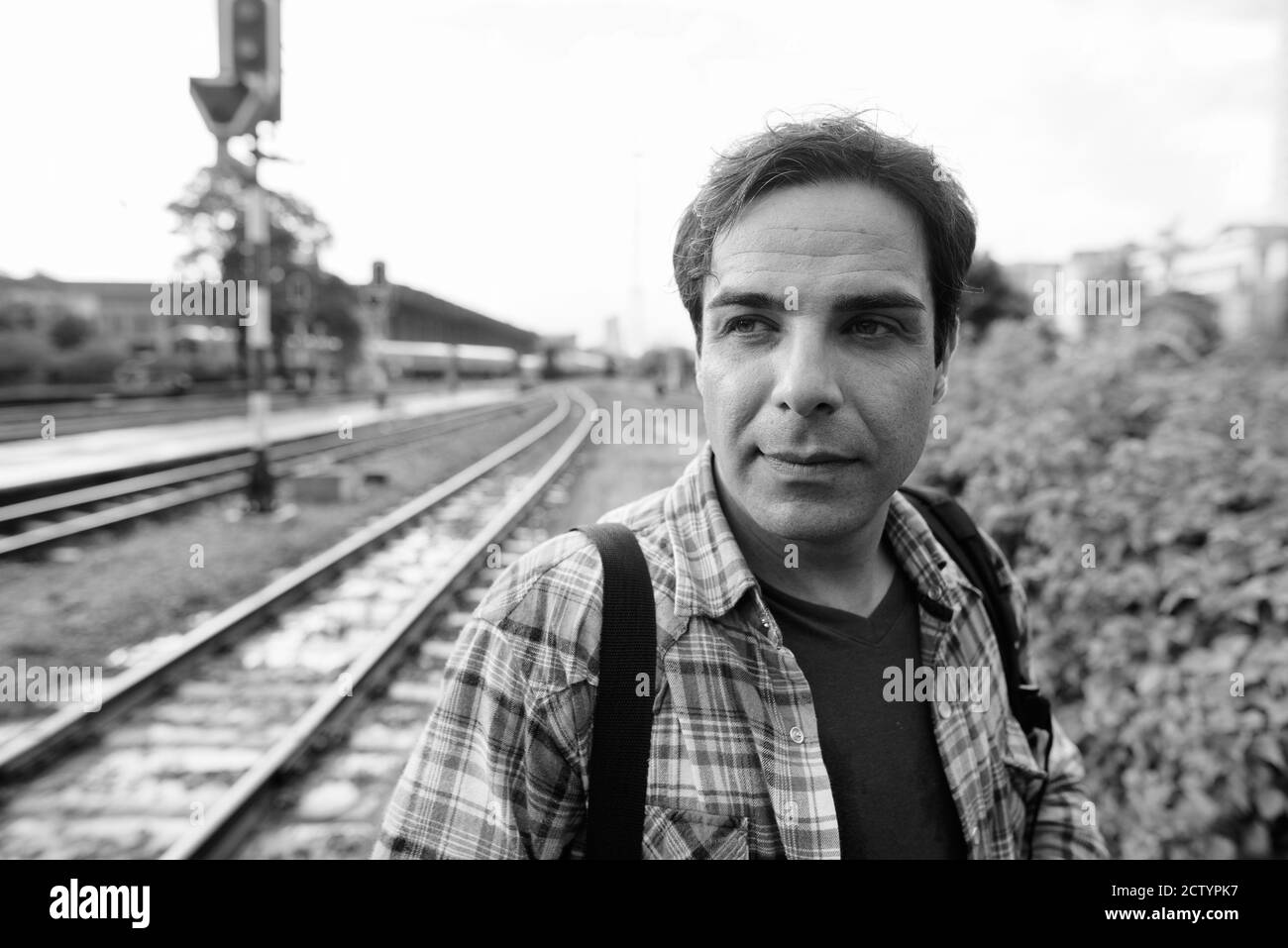 Portrait of handsome Persian tourist man at the railway station Stock Photo