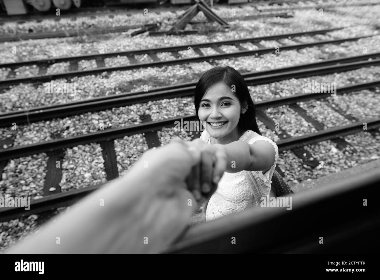 Young beautiful Asian tourist woman at the railway station Stock Photo