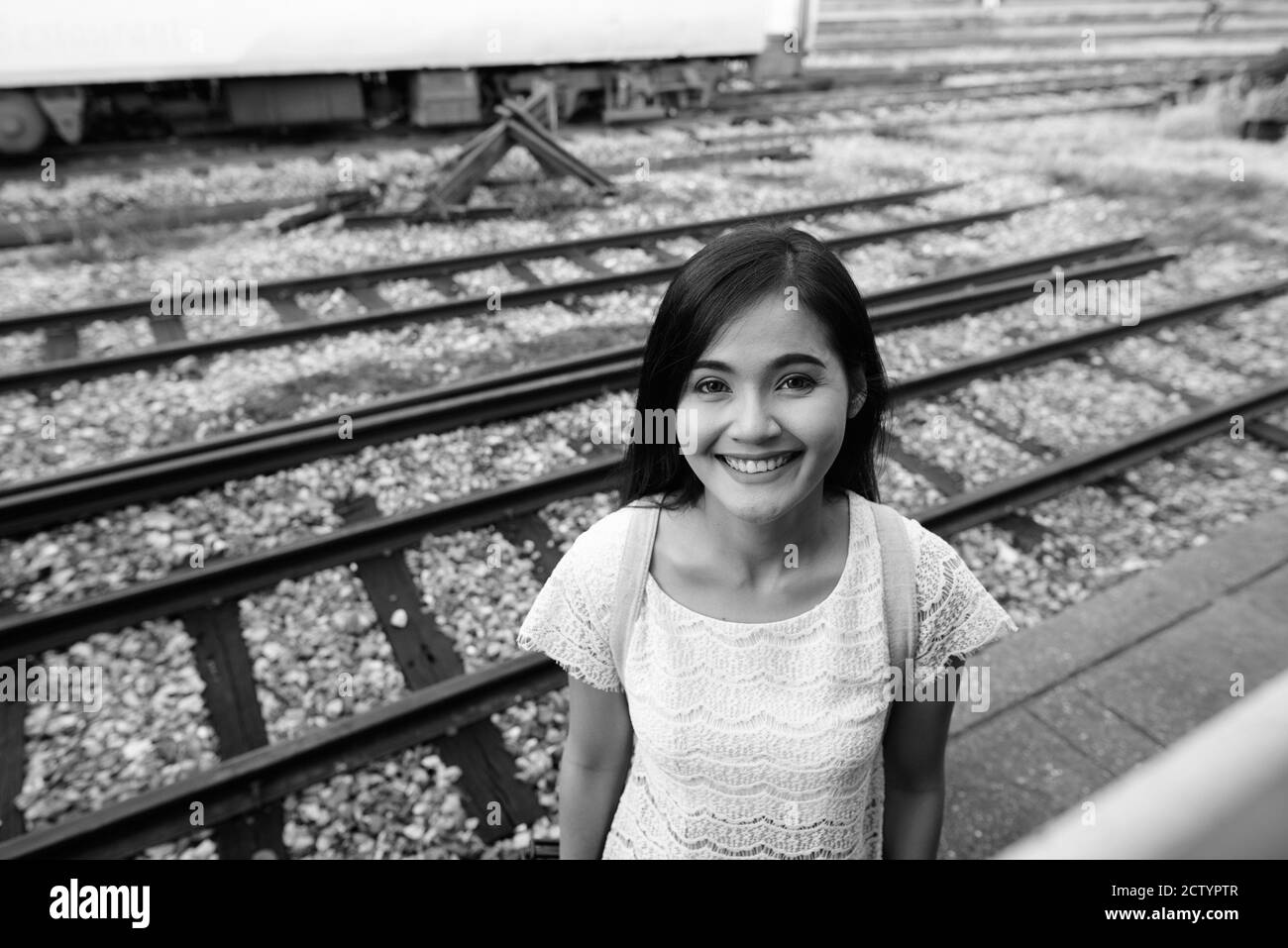 Young beautiful Asian tourist woman at the railway station Stock Photo