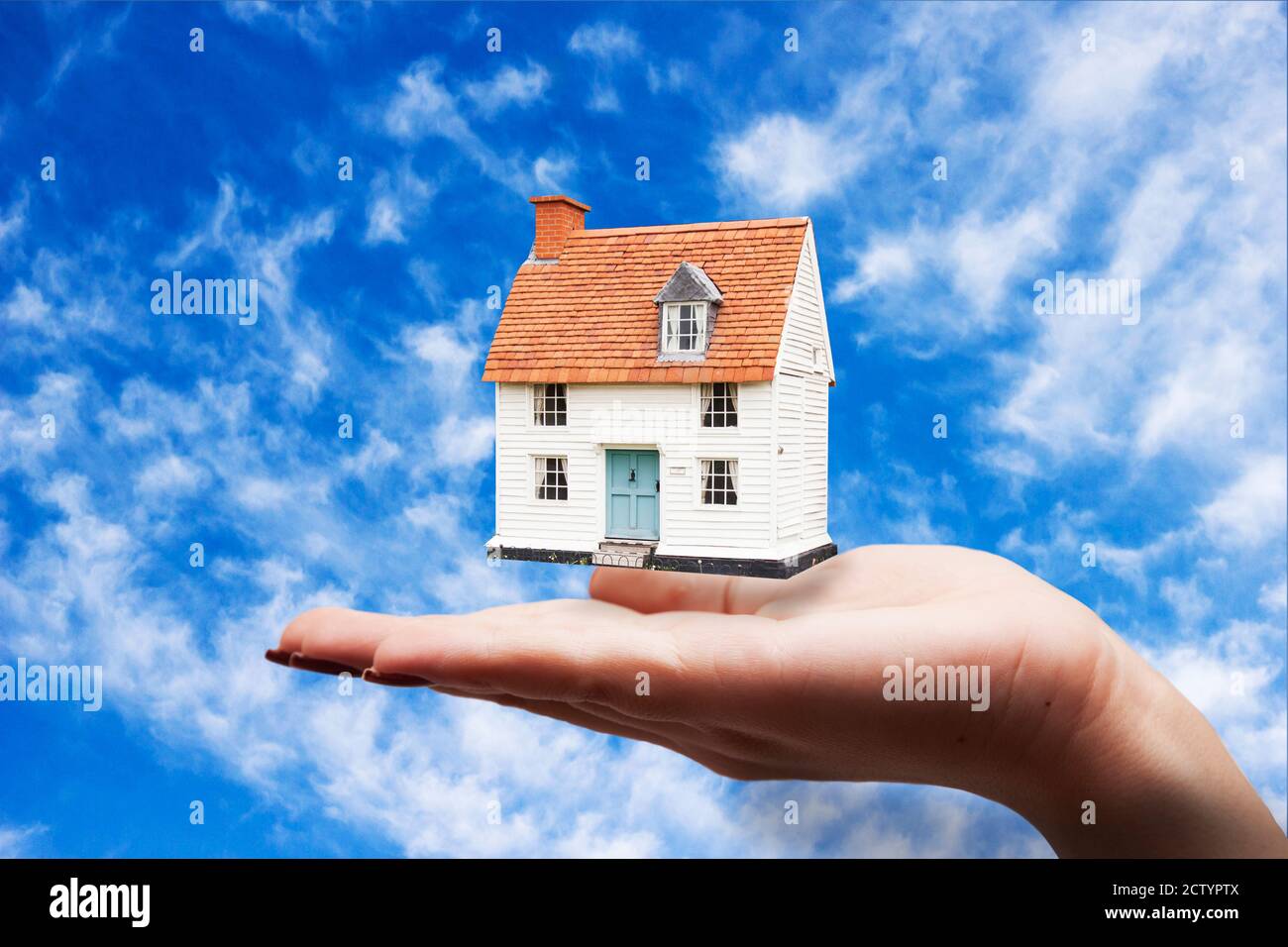 woman hand house in sky background Stock Photo - Alamy