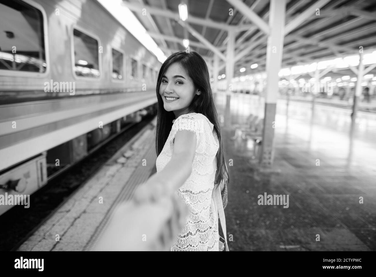Young beautiful Asian tourist woman at the railway station Stock Photo