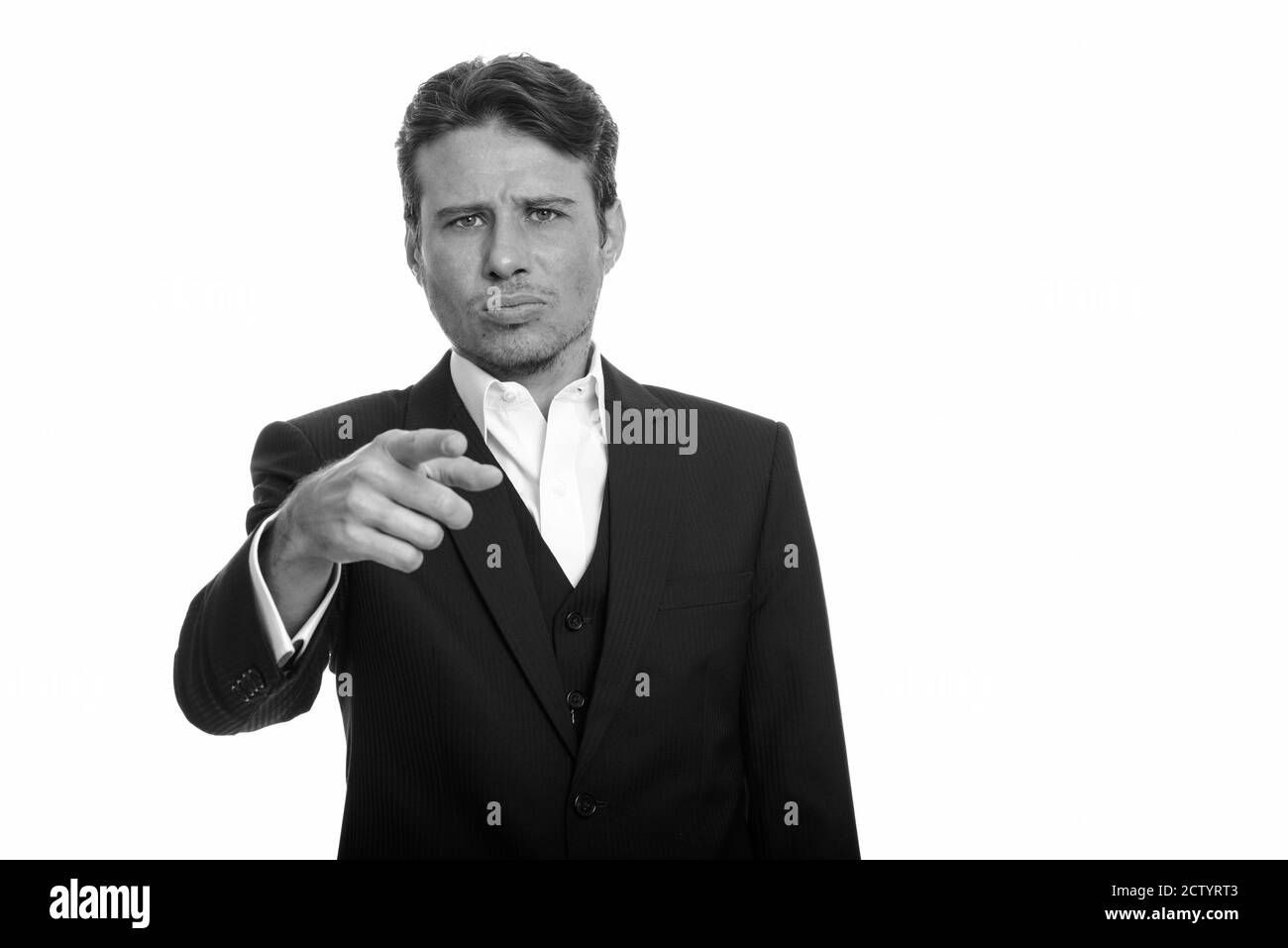 Handsome Caucasian businessman pointing finger while looking angry Stock Photo