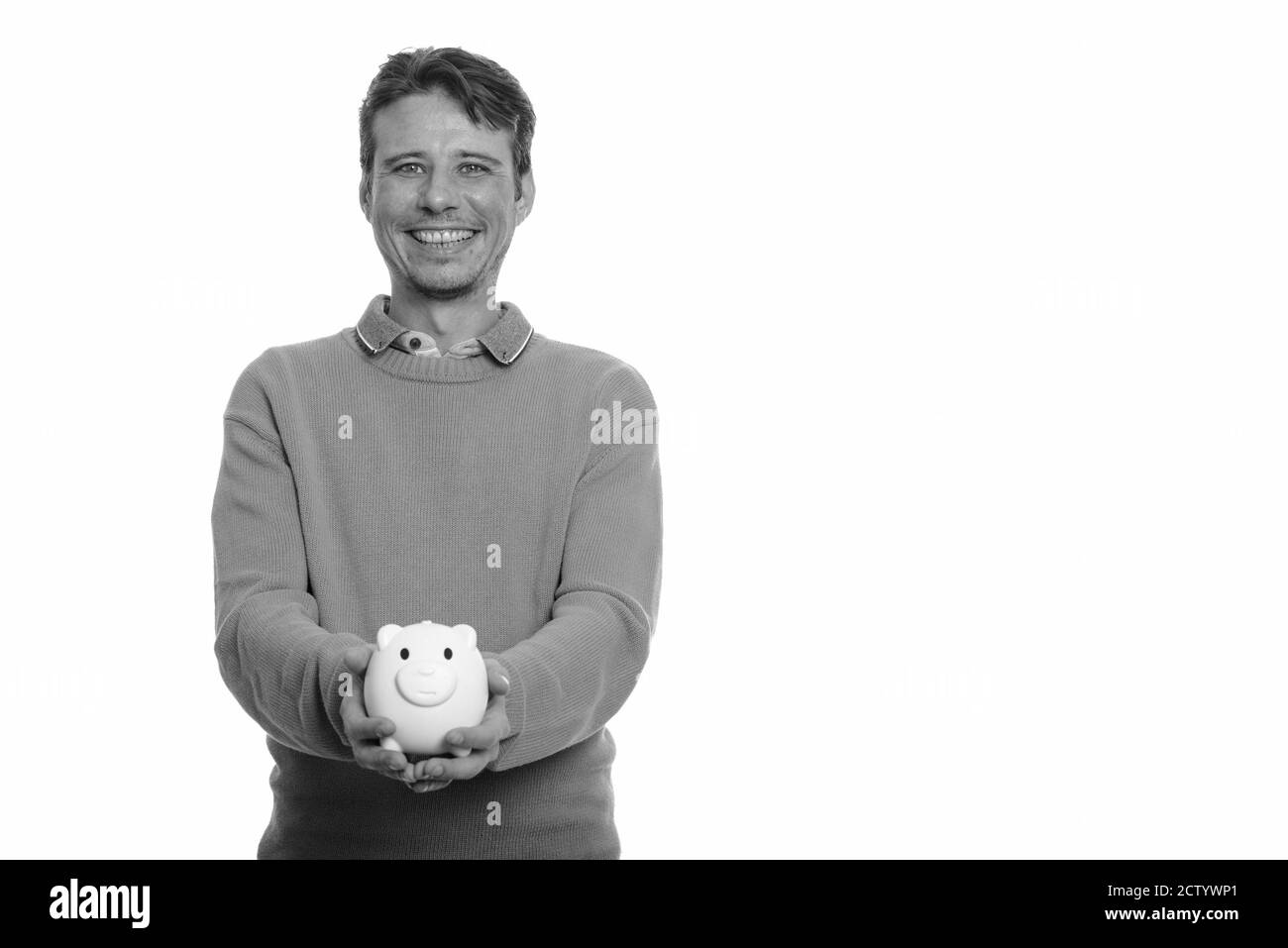Portrait of happy handsome man holding piggy bank Stock Photo - Alamy