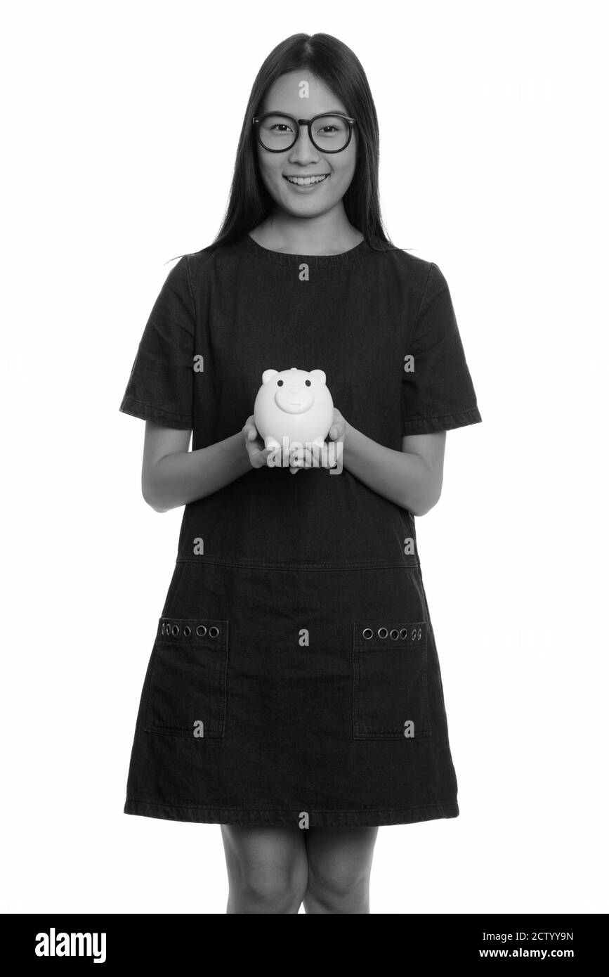 Young happy Asian teenage girl smiling and holding piggy bank Stock ...