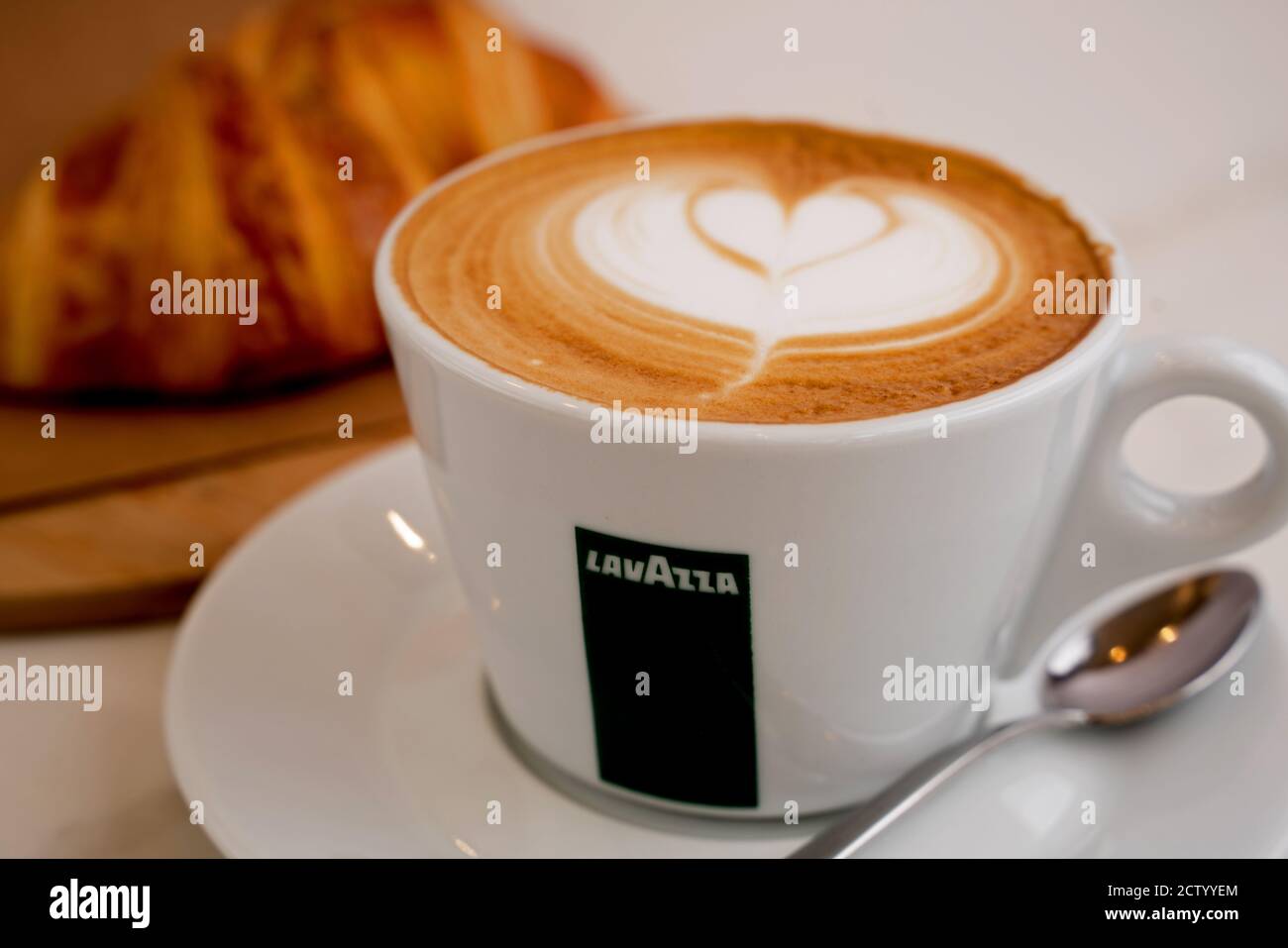 Background image of cappuccino in lavazza cup with croissant on the side Stock Photo Alamy