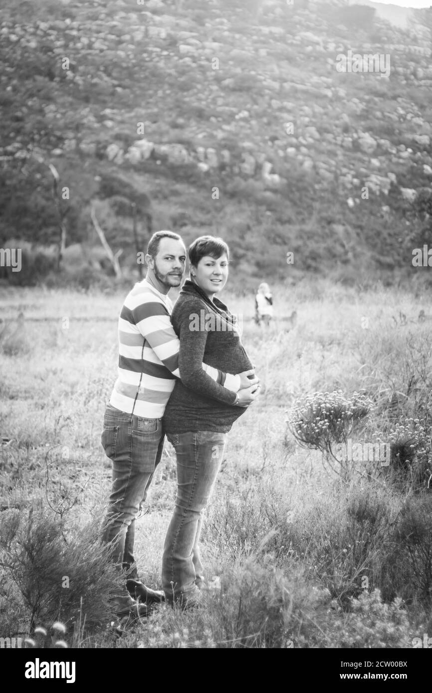 Maternity photo shoot, a father and pregnant mother in a gentle