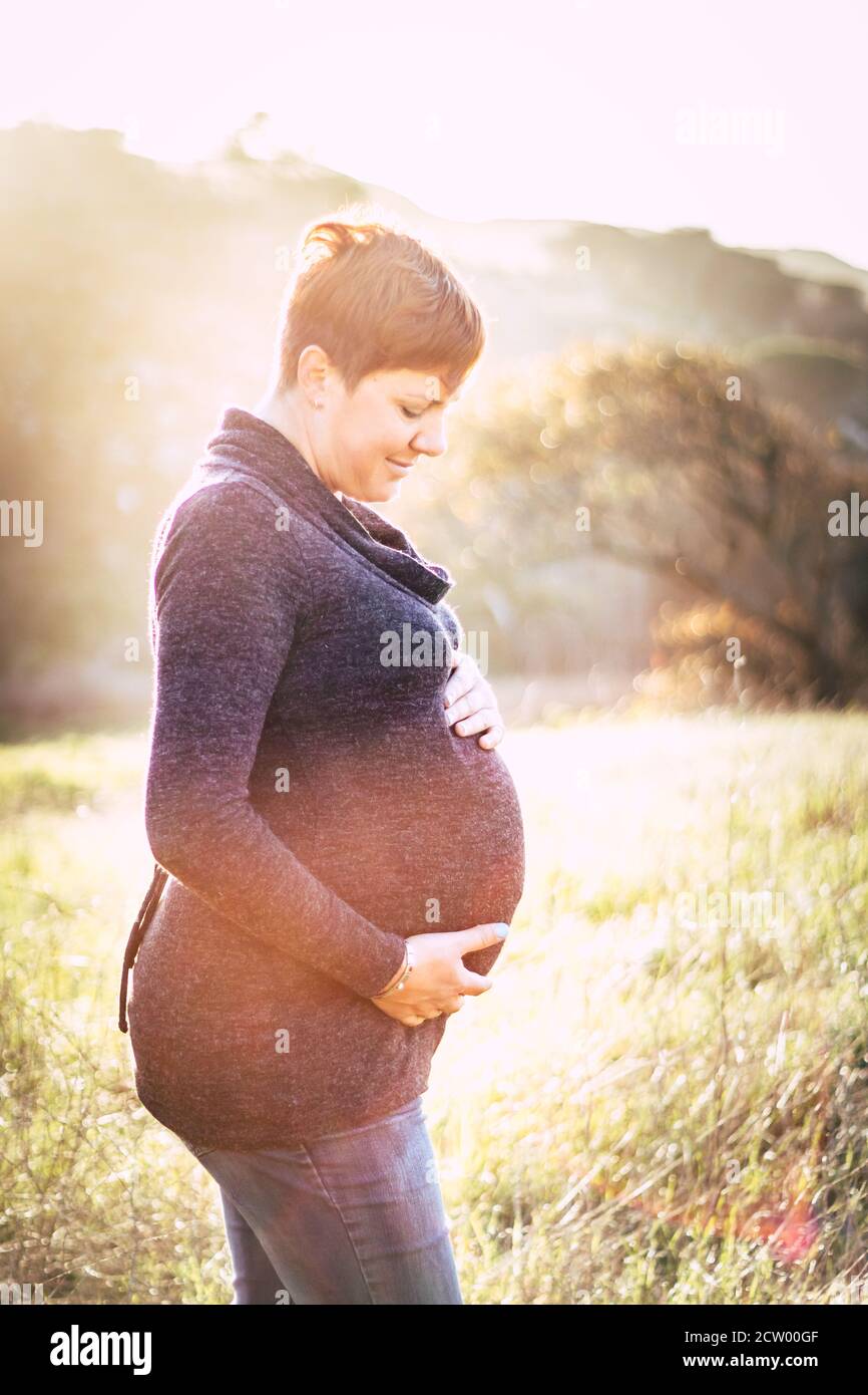 Maternity photo shoot, a pregnant mother looking at her pregnant