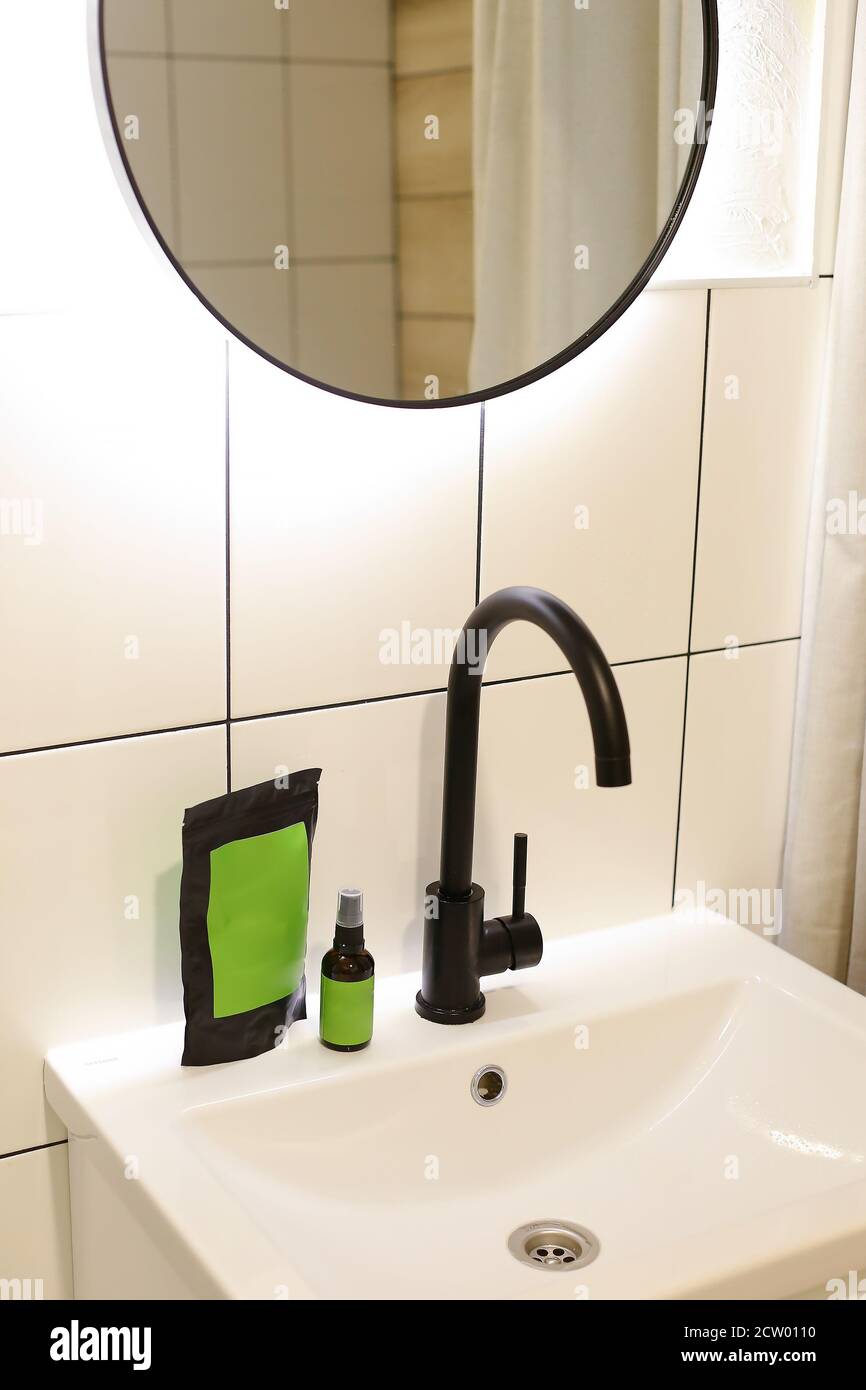 Doy pack and spray bottle with green space for your brand in bathroom. Stock Photo