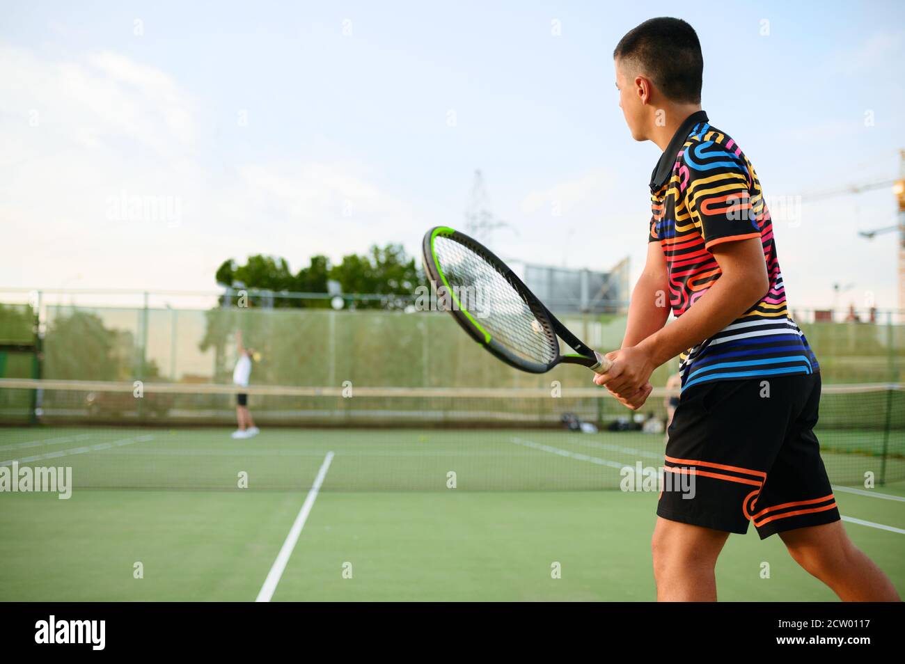 Athletic tennis players, training on outdoor court Stock Photo