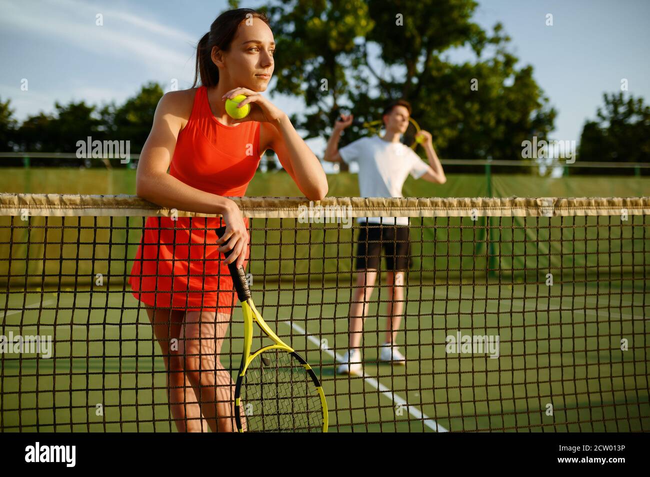 Male and female tennis players with rackets Stock Photo Alamy