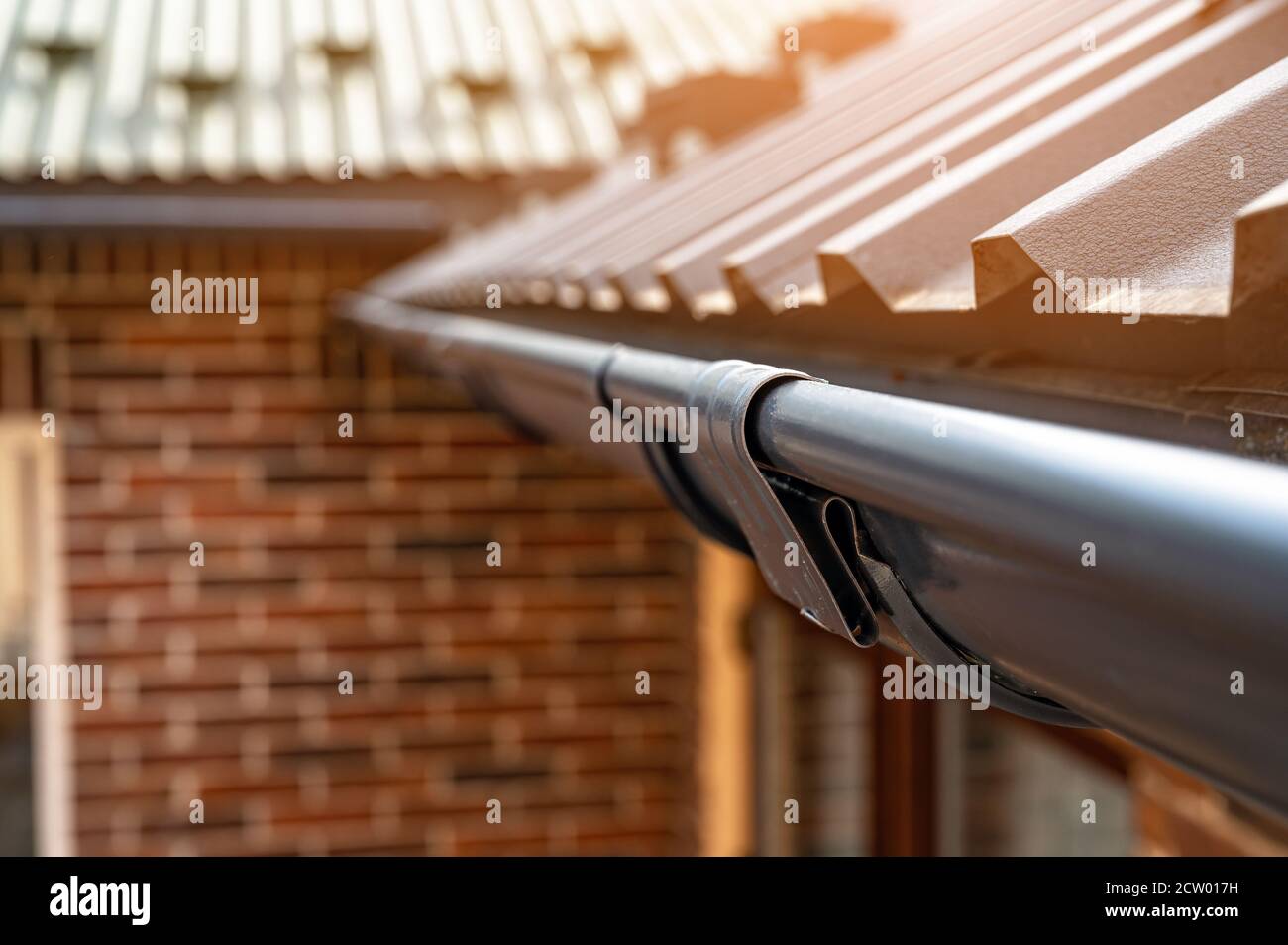 Gutter system for a metal roof. Holder gutter drainage system on the