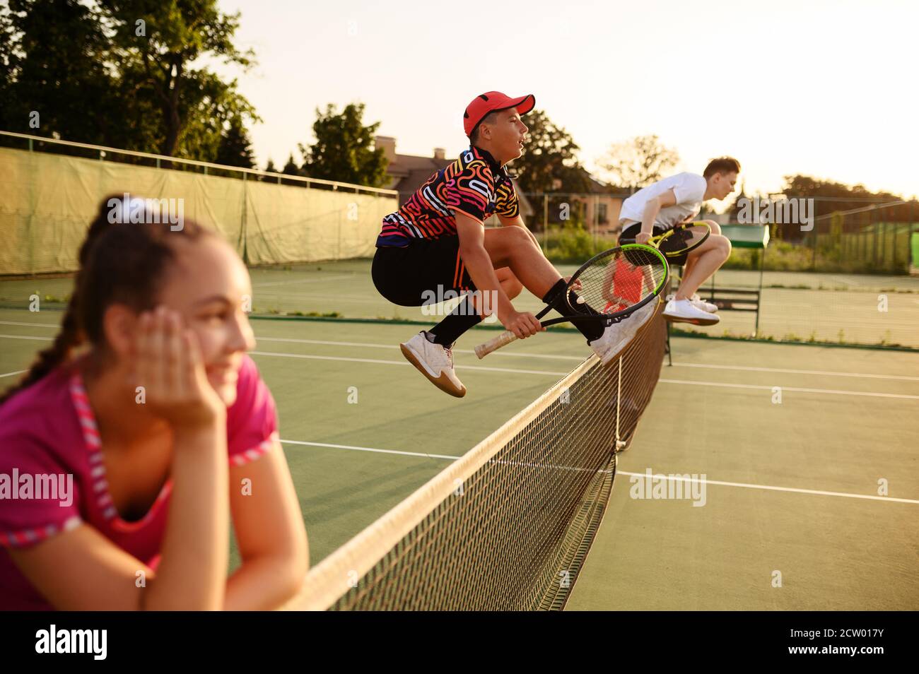 Mixed doubles tennis, players jump through the net Stock Photo Alamy