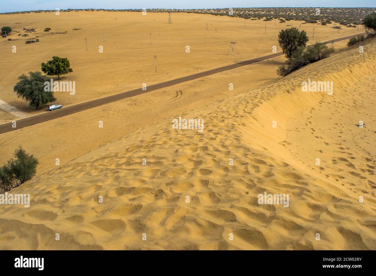 Highway, path, road in Desert of Rajasthan, India, Road passing through a landscape, Jaisalmer, Rajasthan Stock Photo