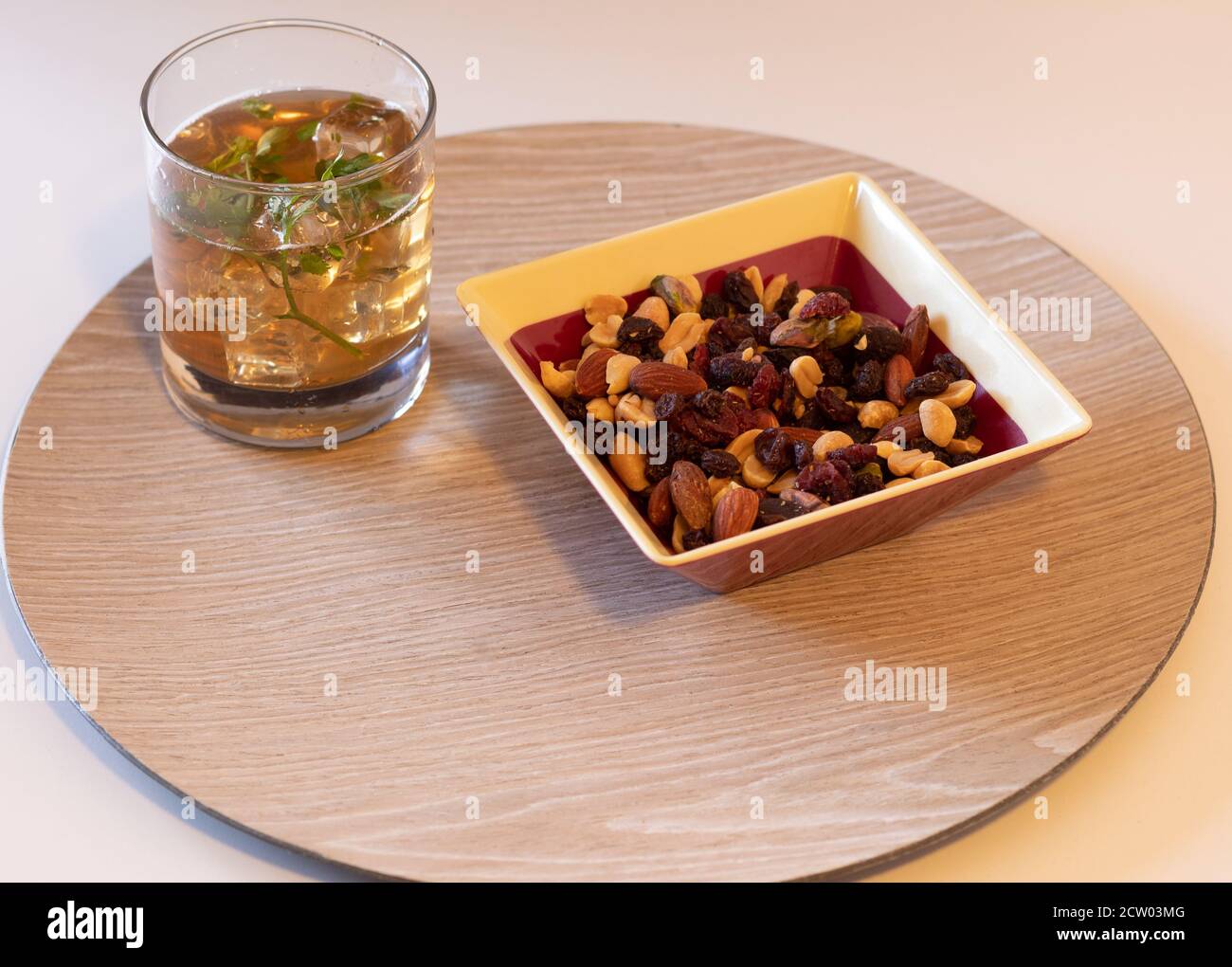 refreshing iced tea drink for a summer day or a hot day with a nutty snack Stock Photo