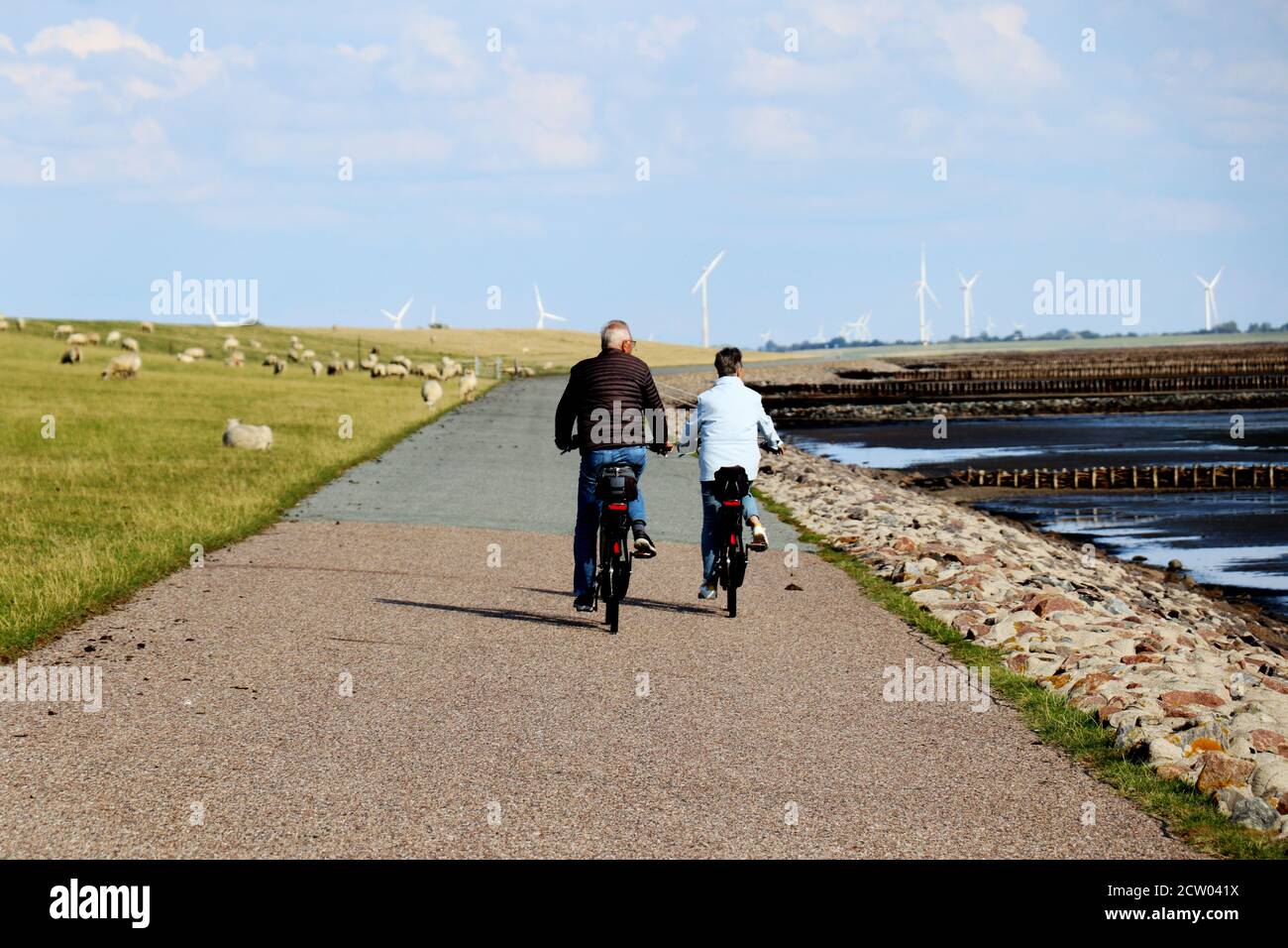 Senior couple cycling alongside the sea - free time using for sport activities Stock Photo