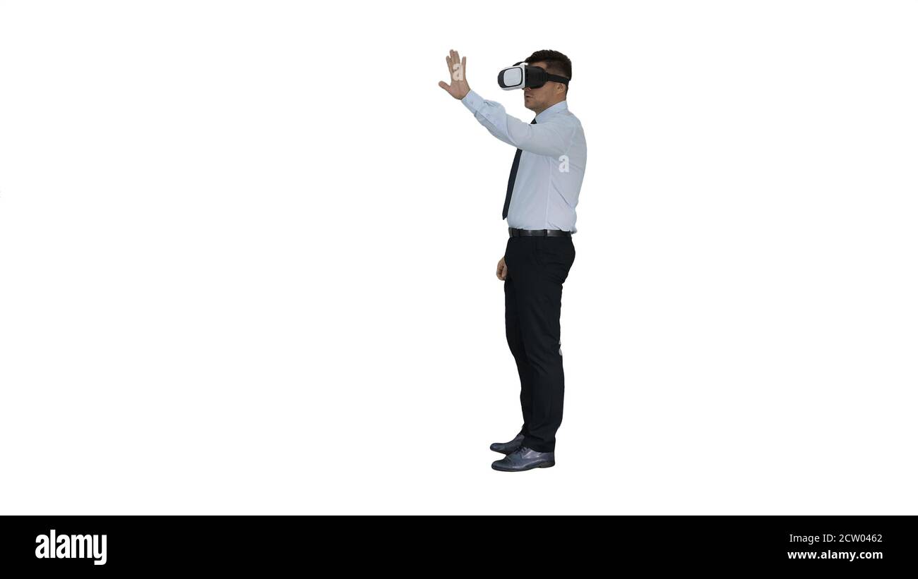 Young businessman using vr headset on white background. Stock Photo