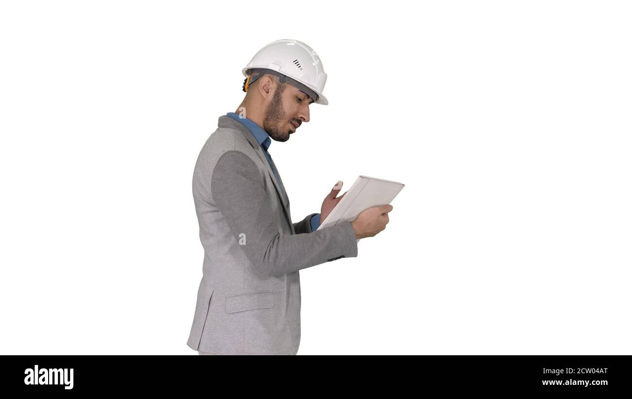 The hipster engineer making video call with tablet showing result of his work on white background. Stock Photo