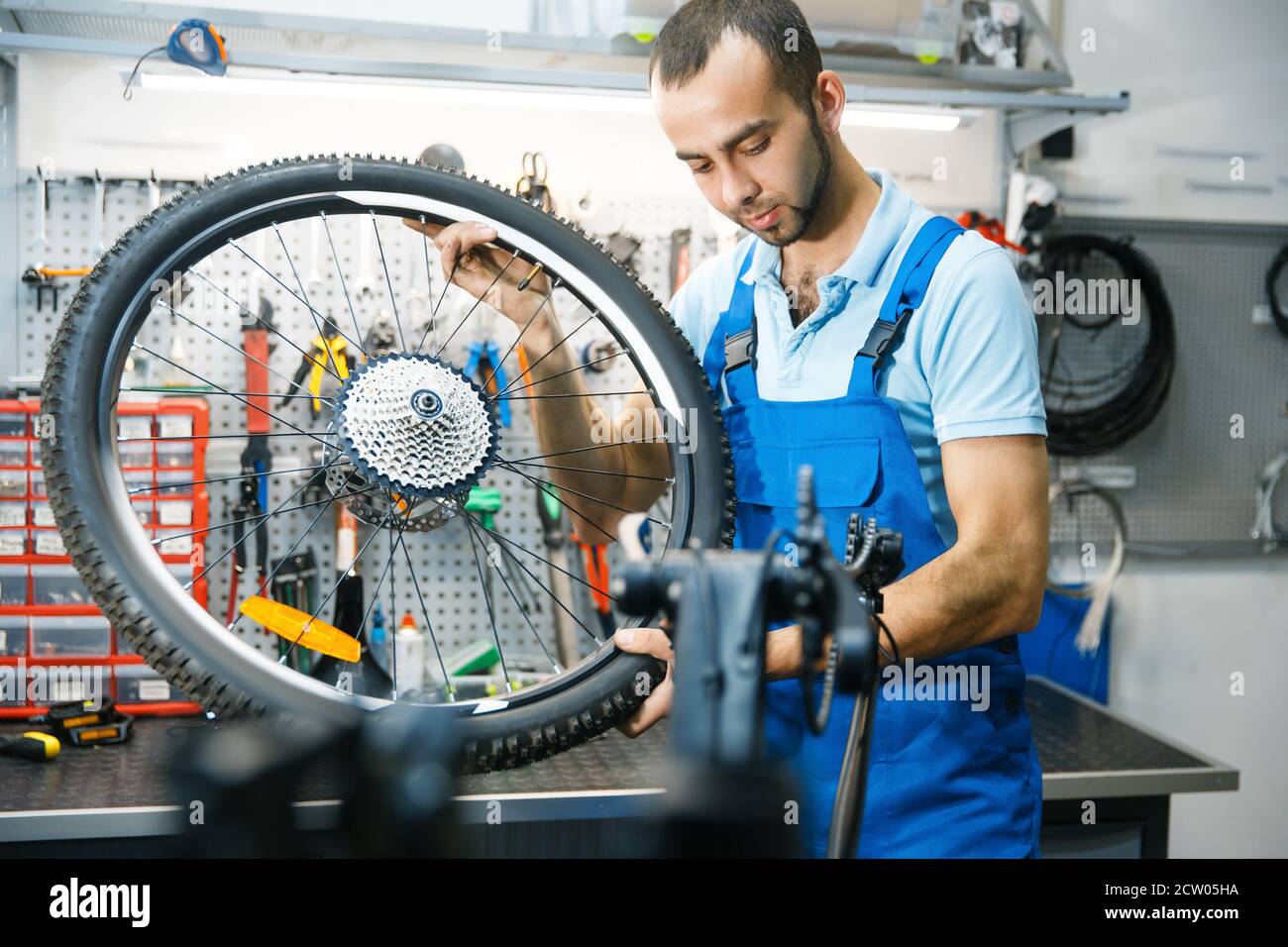 Bicycle assembly in workshop, wheel installation Stock Photo