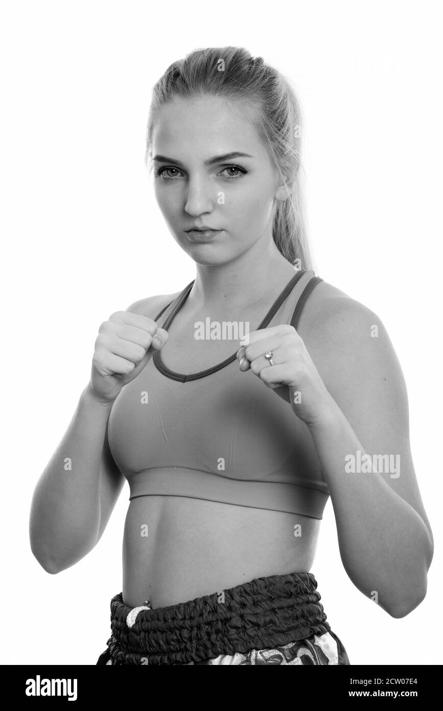 Studio shot of young beautiful teenage girl muay thai fighter ready to fight Stock Photo