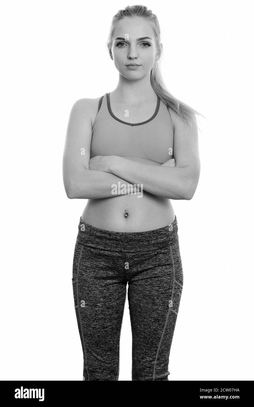 Studio shot of young beautiful teenage girl standing with arms crossed ready for gym Stock Photo
