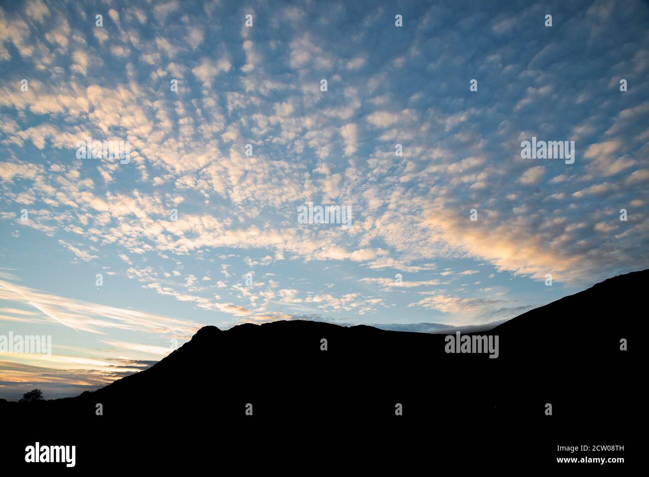 Stunning landscape image of colorful mackerel sky cloud formation in late Summer Stock Photo