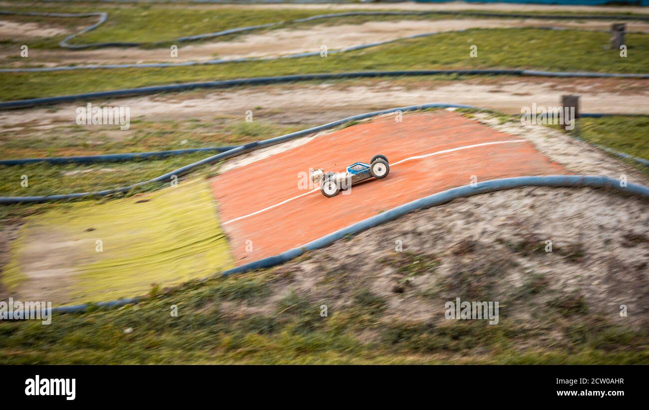 Offroad RC buggy driving on an outdoor dirt track Stock Photo