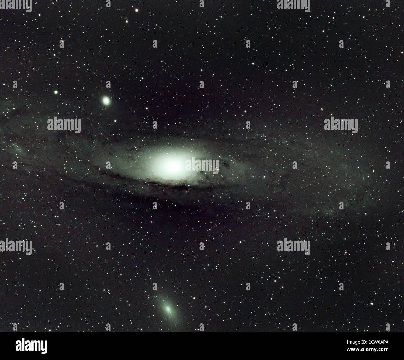The Andromeda Galaxy M31 (2.5 million light years distant) against a  foreground of fainter stars in the home galaxy. Galaxy M110 is below and  smaller Galaxy M32 to upper left. Telescope image