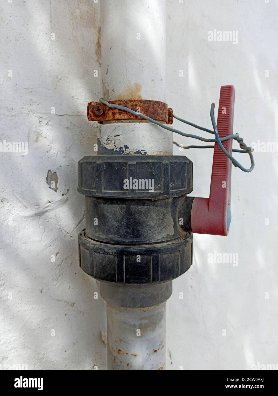 Water pipe with a shut-off valve screwed in between. Stock Photo