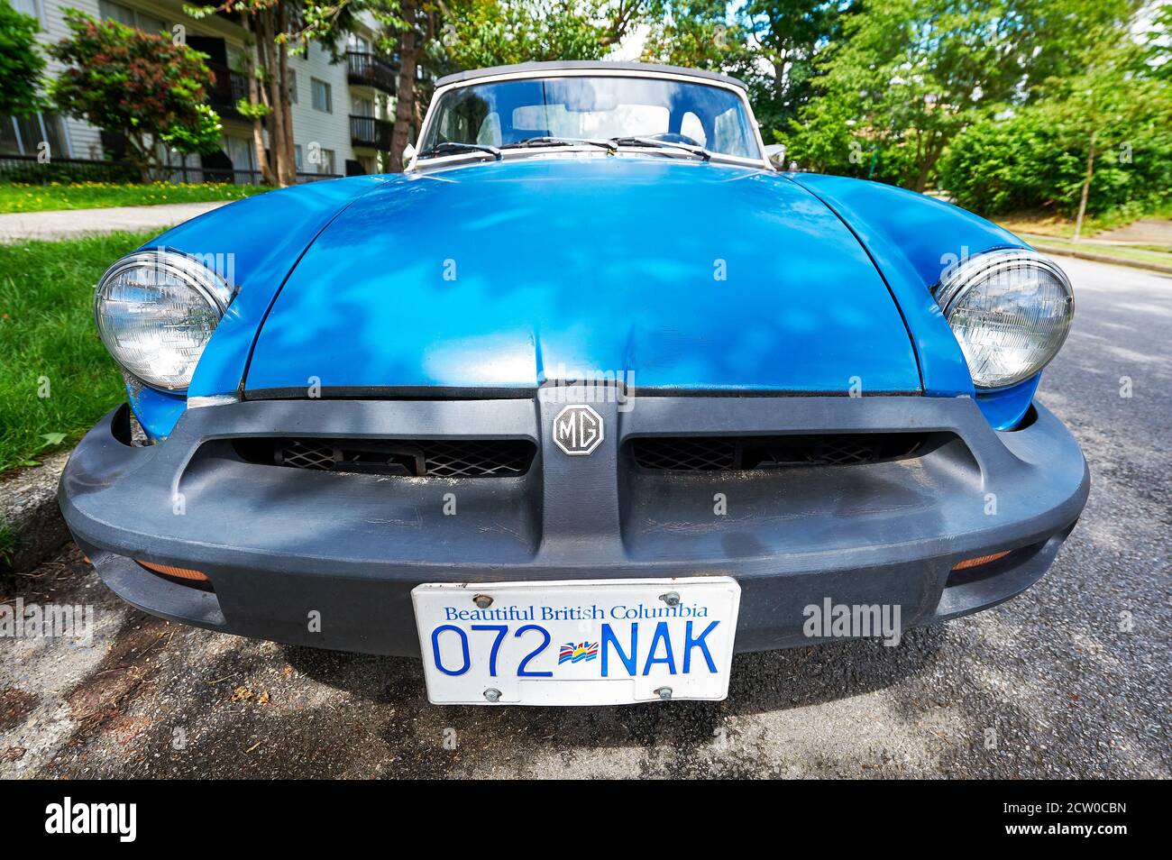Isolated front view of a blue colored 1975 North American rubber bumper MG MGB convertible MG sports car seen in Vancouver, British Columbia, Canada Stock Photo