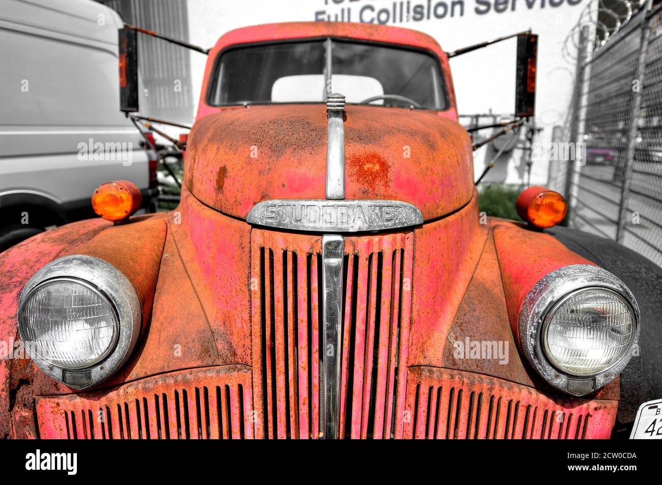 Front view of an old red colored rusty Studebaker truck parked along a road in Vancouver City, British Columbia, Canada Stock Photo