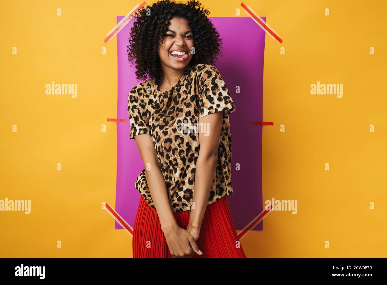 Image of funny african american woman showing her tongue isolated over