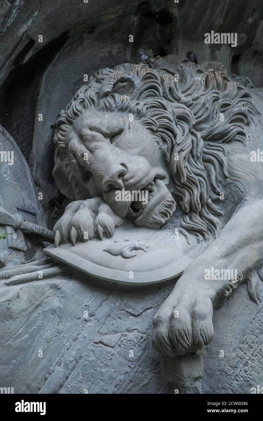 The Lion Monument or the Lion of Lucerne, a giant dying lion carved out of a wall of sandstone rock Stock Photo
