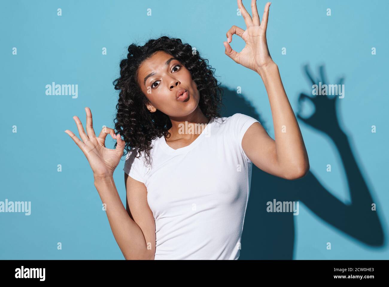 Image of amusing african american woman gesturing ok sign isolated over ...