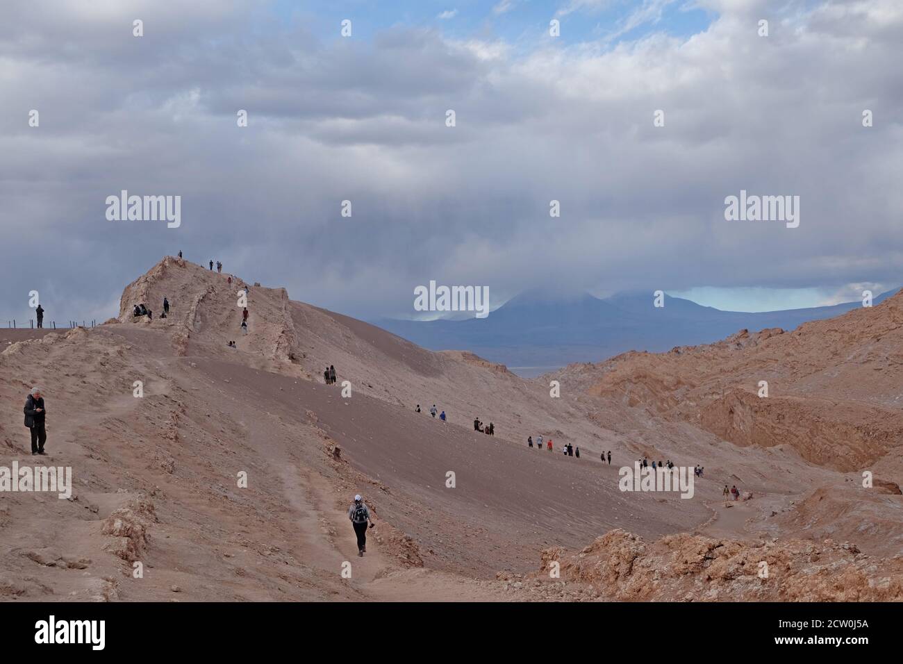 Tourists hiking over the lunar landscape of the salt encrusted Valle de la Luna,Atacama Stock Photo
