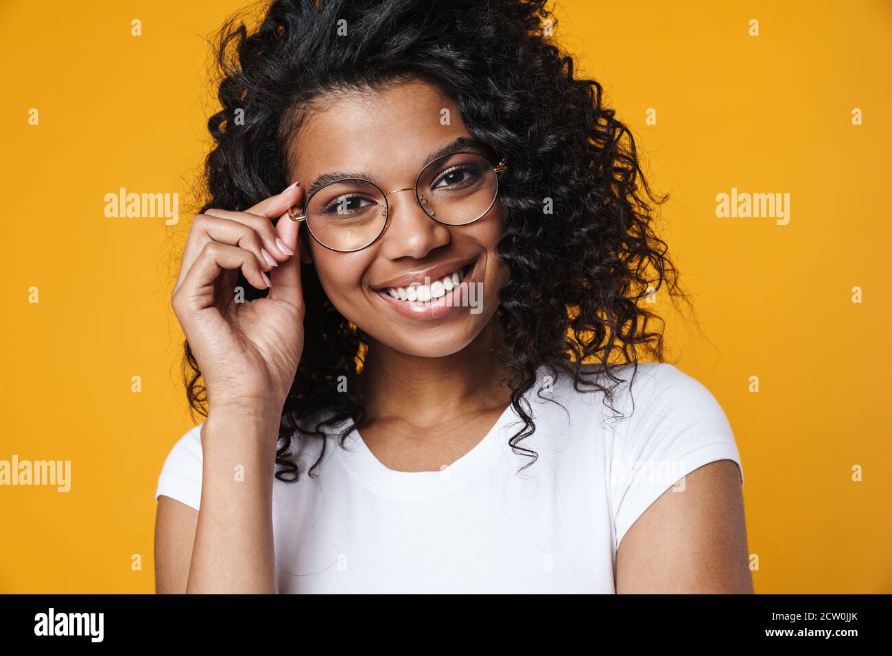 Image of happy african american girl in eyeglasses smiling at camera ...