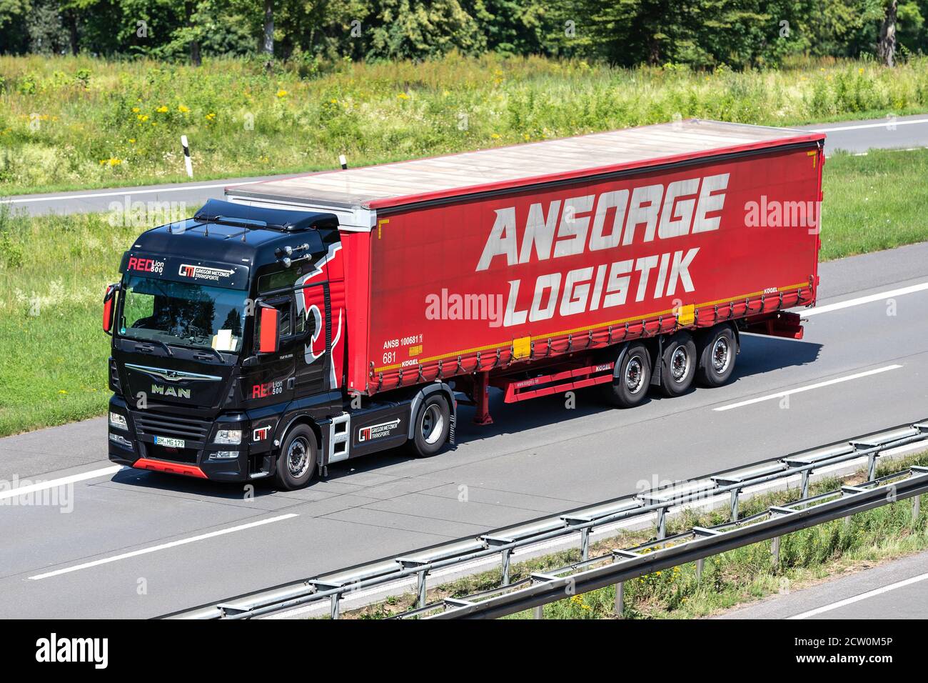 Gregor Metzner MAN TGX truck with Ansorge Logistik curtainside trailer on motorway. Stock Photo