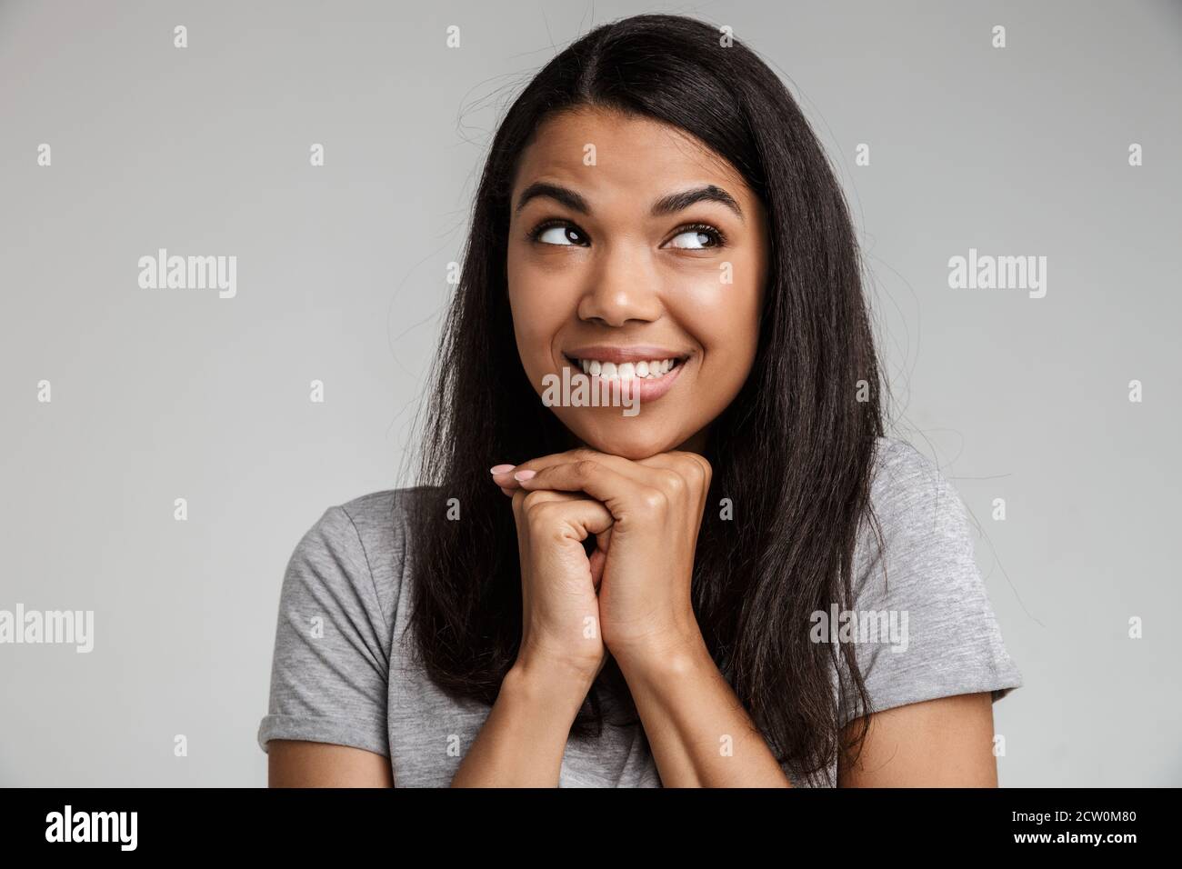 Portrait of a happy smiling young african woman with long dark hair ...