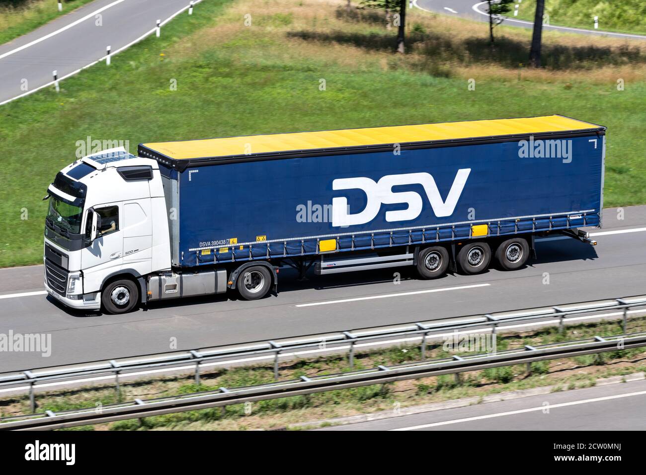 Volvo FH truck with DSV curtainside trailer on motorway. Stock Photo