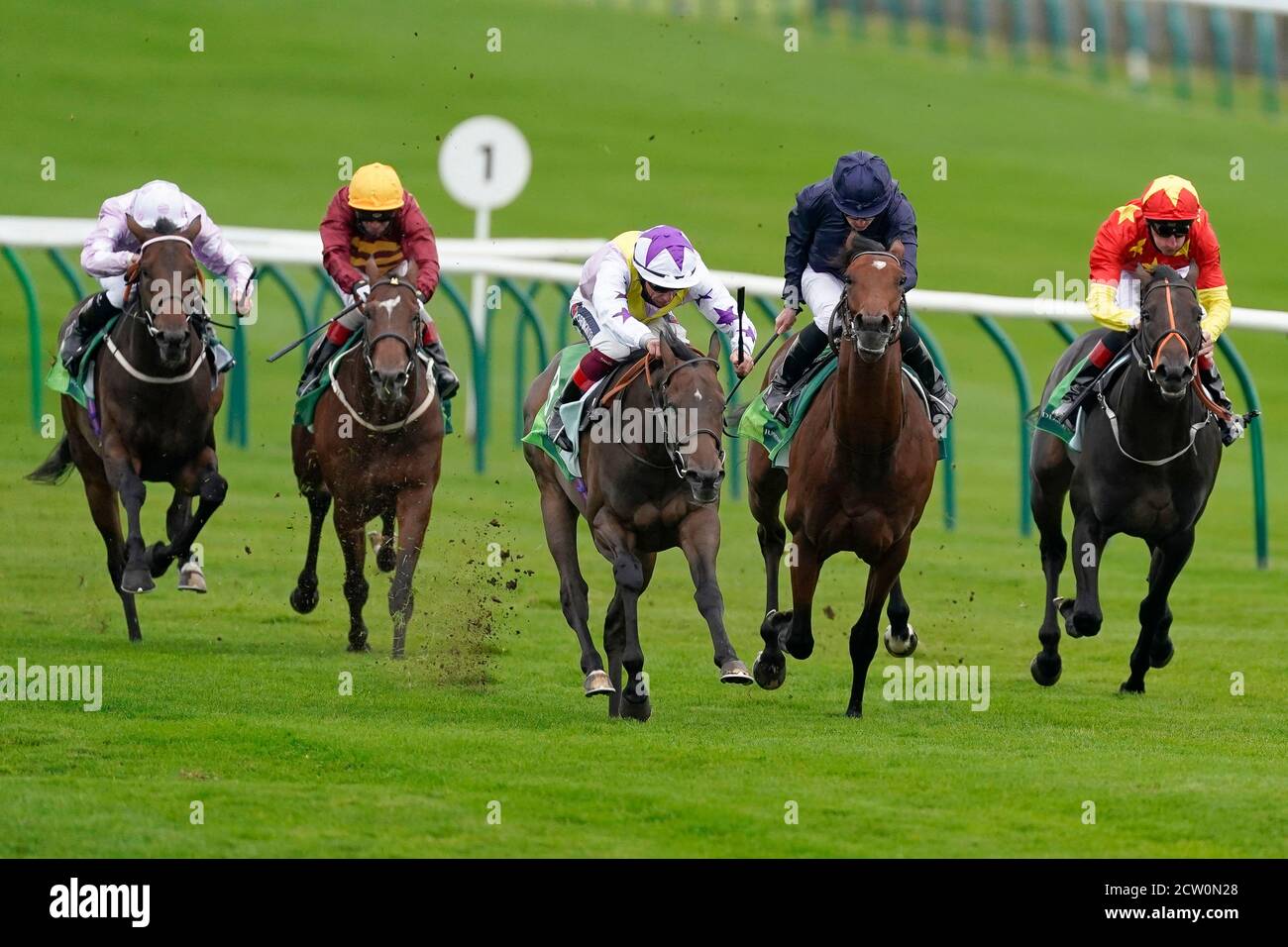 Frankie Dettori riding New Mandate (centre) win The Juddmonte Royal Lodge Stakes from Ryan Moore and Ontario (second right) during day three of The Cambridgeshire Meeting at Newmarket Racecourse. Stock Photo