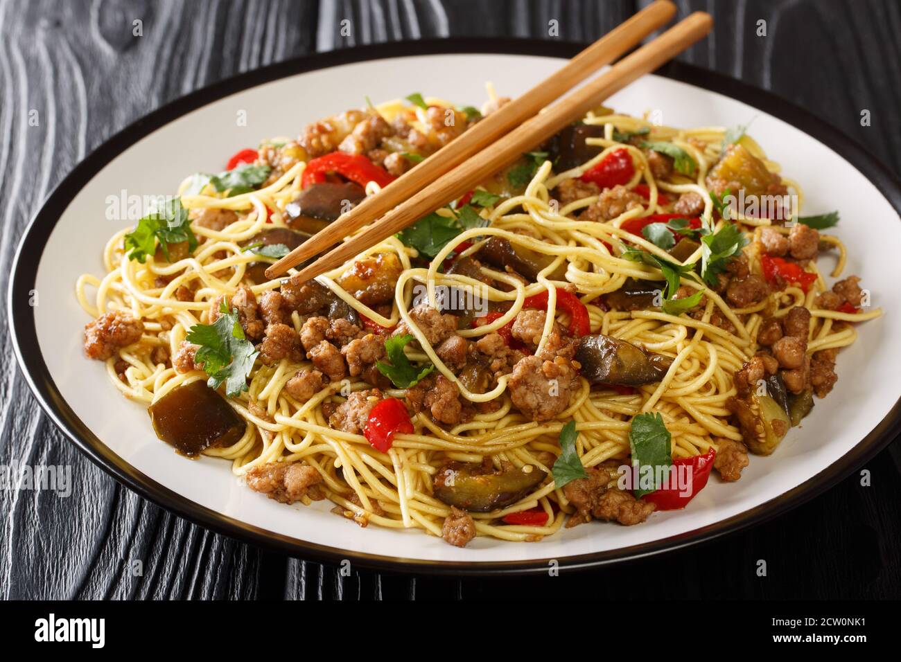 Chinese fried eggplant with minced meat, egg noodles, garlic and herbs