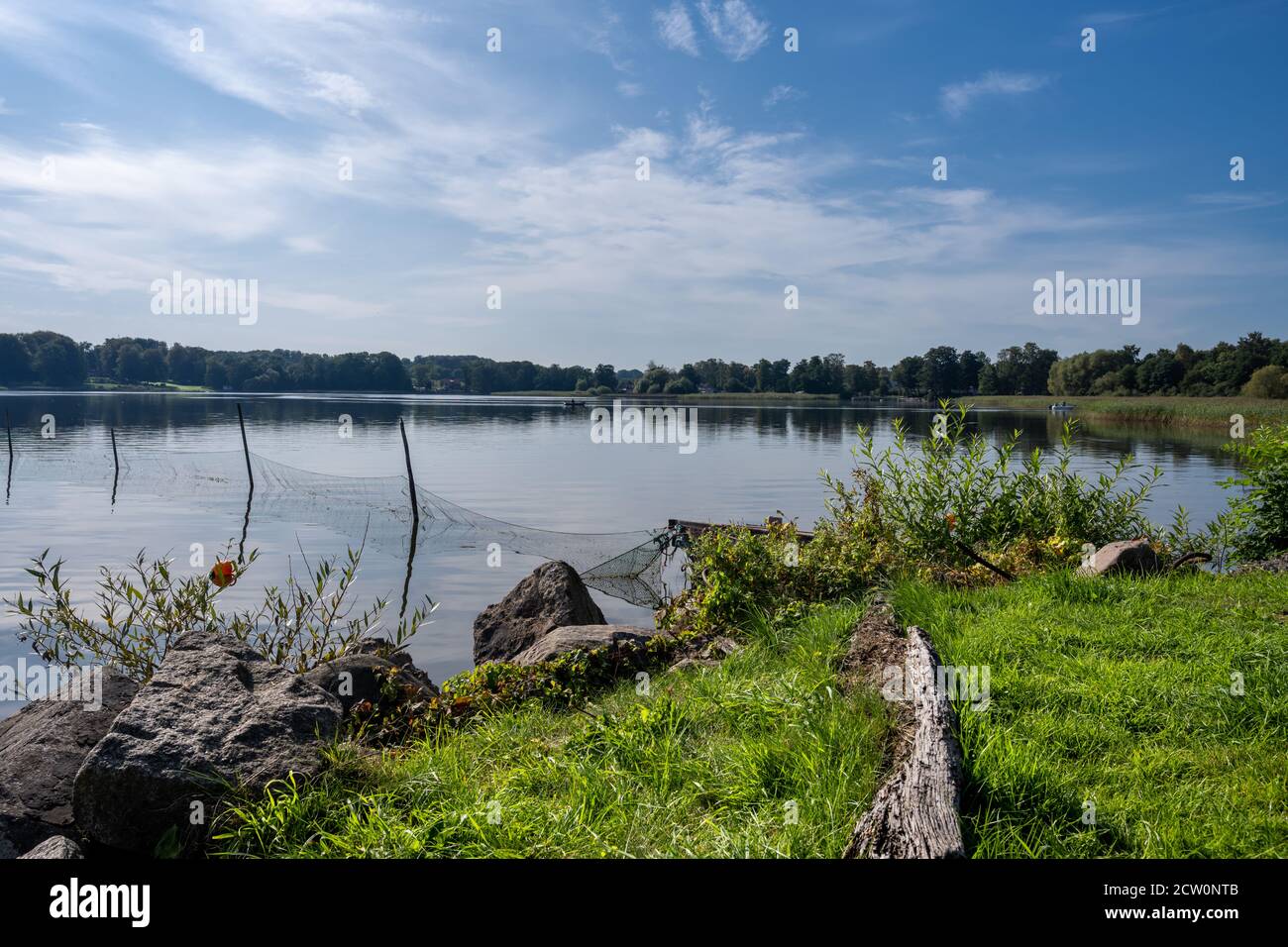 A fishing net in a beautiful lake. Blue sky and water in the background ...