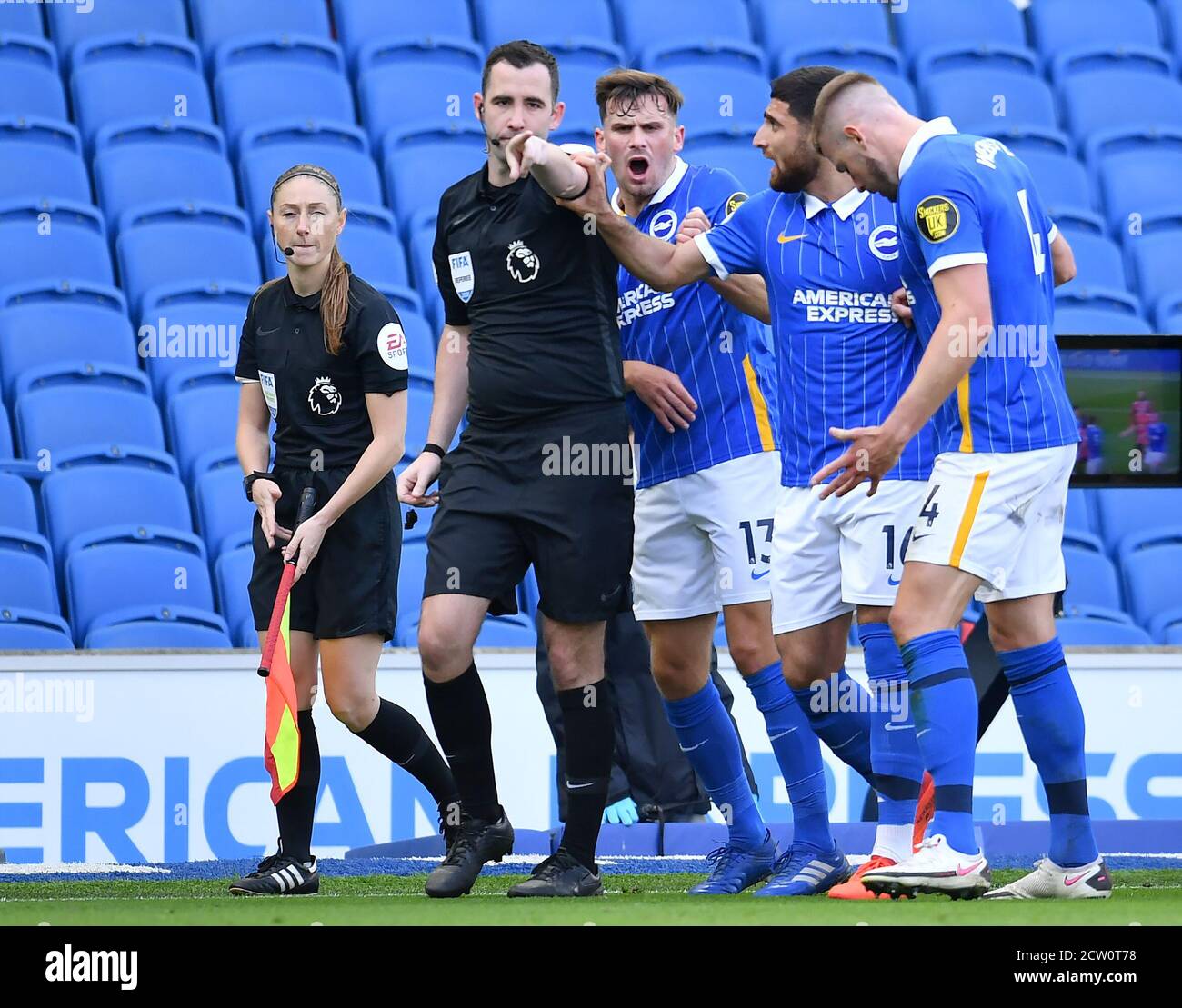 Match referee Chris Kavanagh awards a late penalty to Manchester United despite the protests of the Brighton and Hove Albion players during the Premier League match at the AMEX Stadium, Brighton. Stock Photo