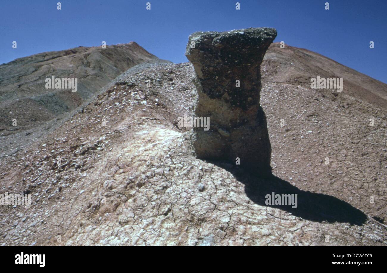 Historical 1970s Photo:   Oddly shaped outcroppings often appear on the mounds of red clay and shale that mark the sites of abandoned deep mines scattered throughout north central illinois. the one shown here is near the town of Standard IL ca.  June 1973 Stock Photo