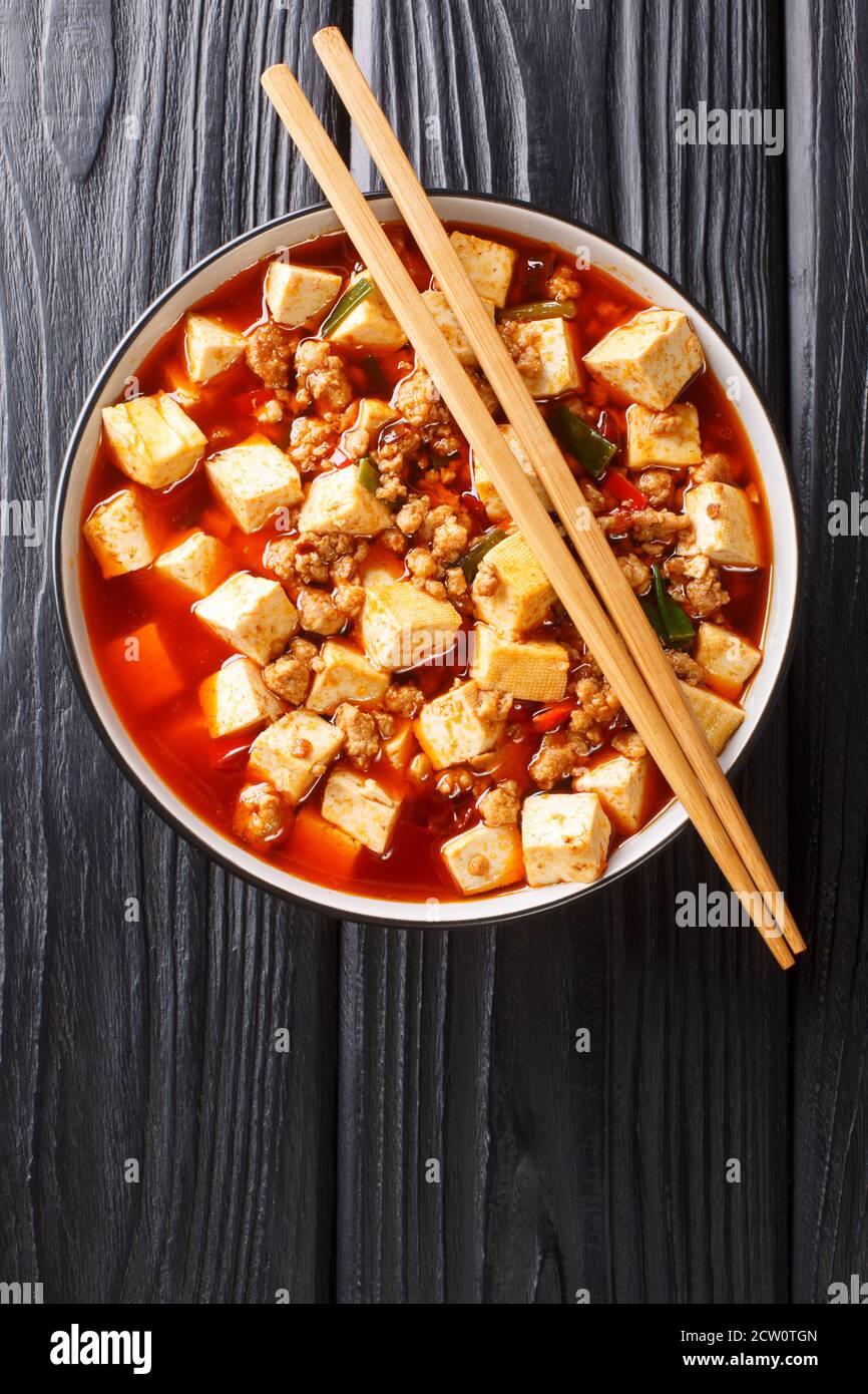 Mapo Tofu classic recipe consists of silken tofu, ground pork, fermented beans, fermented black beans, and Sichuan peppercorn closeup in the plate on Stock Photo