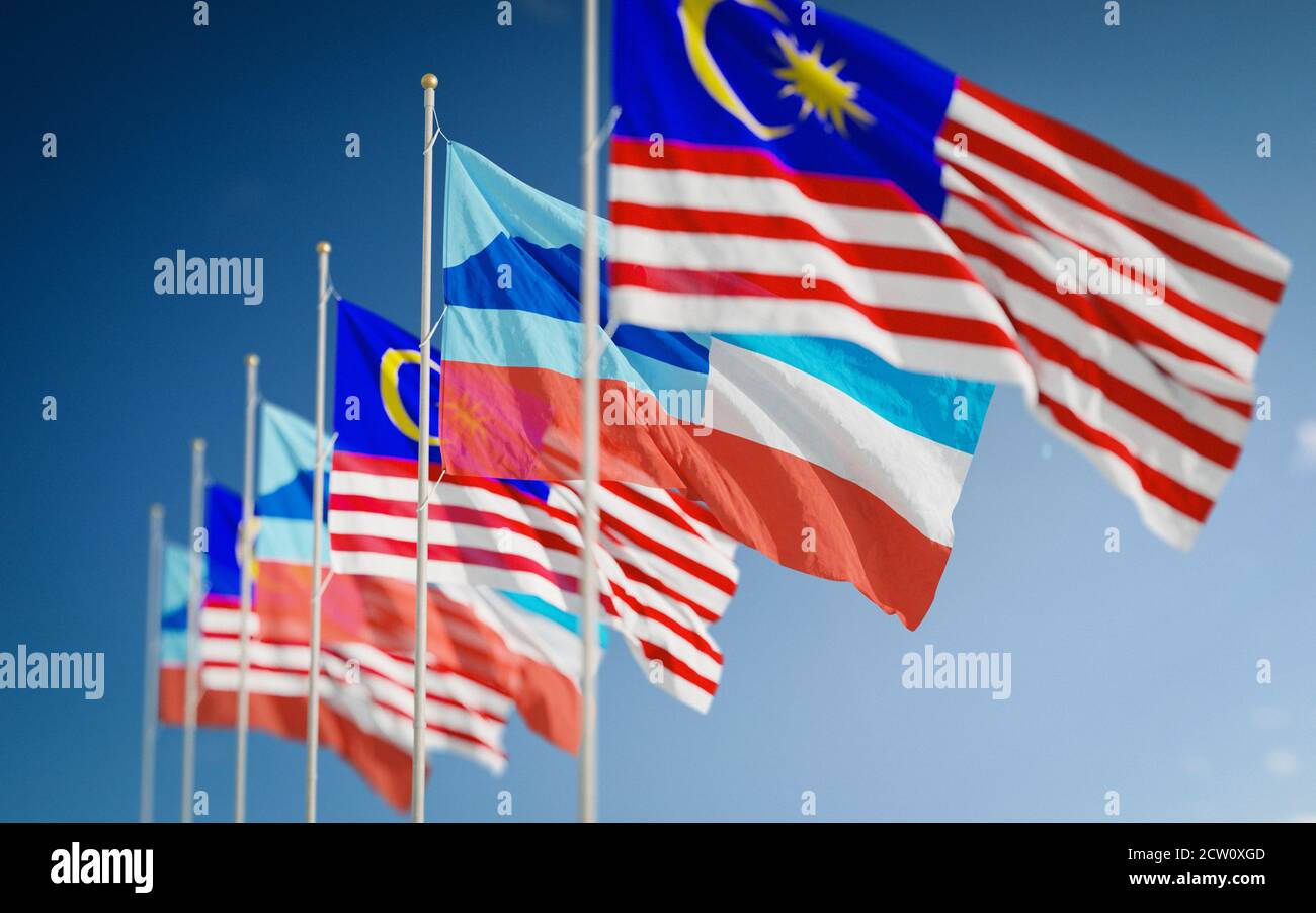 Waving flags of Borneo Sabah State and Malaysia against a beautiful sky background Stock Photo