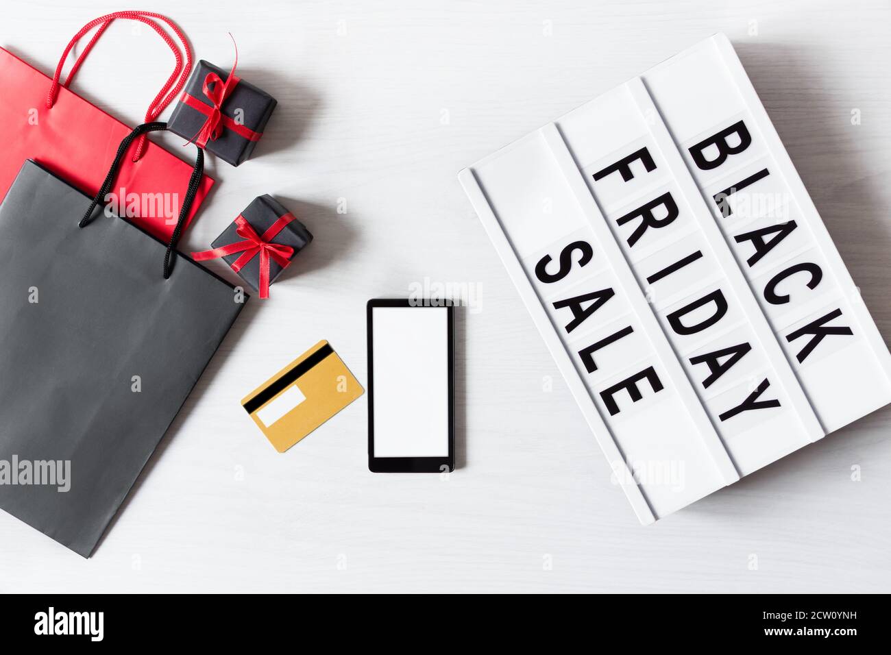 Lightbox with black Friday text, blank smart phone for online shopping