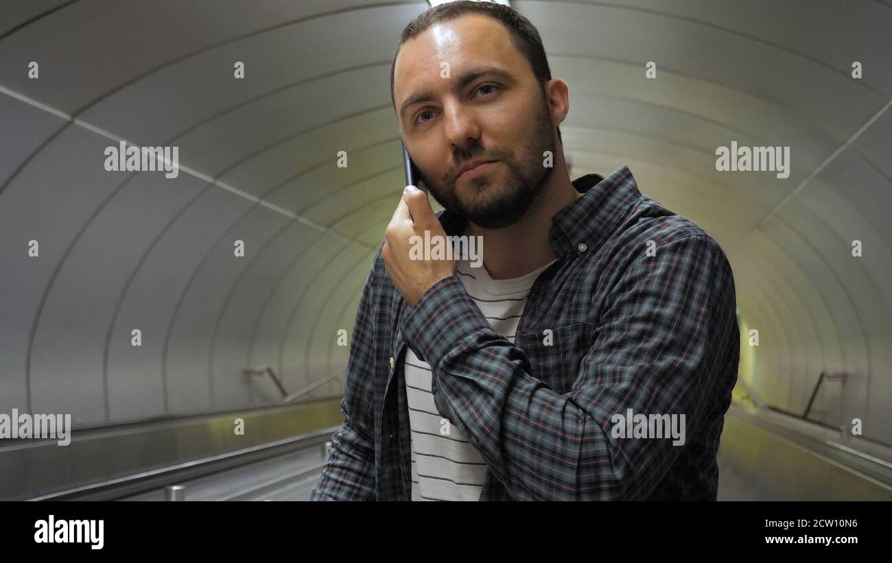 Cheerful man calling to friend. Stock Photo