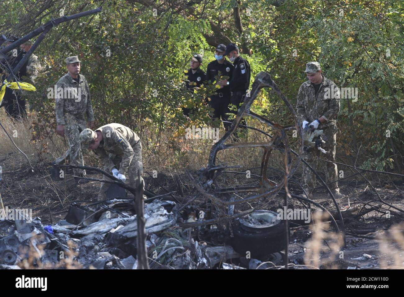(200926) -- KHARKIV, Sept. 26, 2020 (Xinhua) -- Rescuers cleans the wreckage of the crashed An-26 military aircraft in Chuguev, Kharkiv region, Ukraine, Sept. 26, 2020. The death toll from the Ukrainian military plane crash rose to 26, after one of the two people with serious condition died in hospital, the State Emergency Service of Ukraine said on Saturday. The An-26 military aircraft with 27 people on board crashed on Friday. The plane was performing a training flight and was landing at the airfield of a military base near the city of Chuguev, Kharkiv region. (Photo by Sergey Starostenko Stock Photo