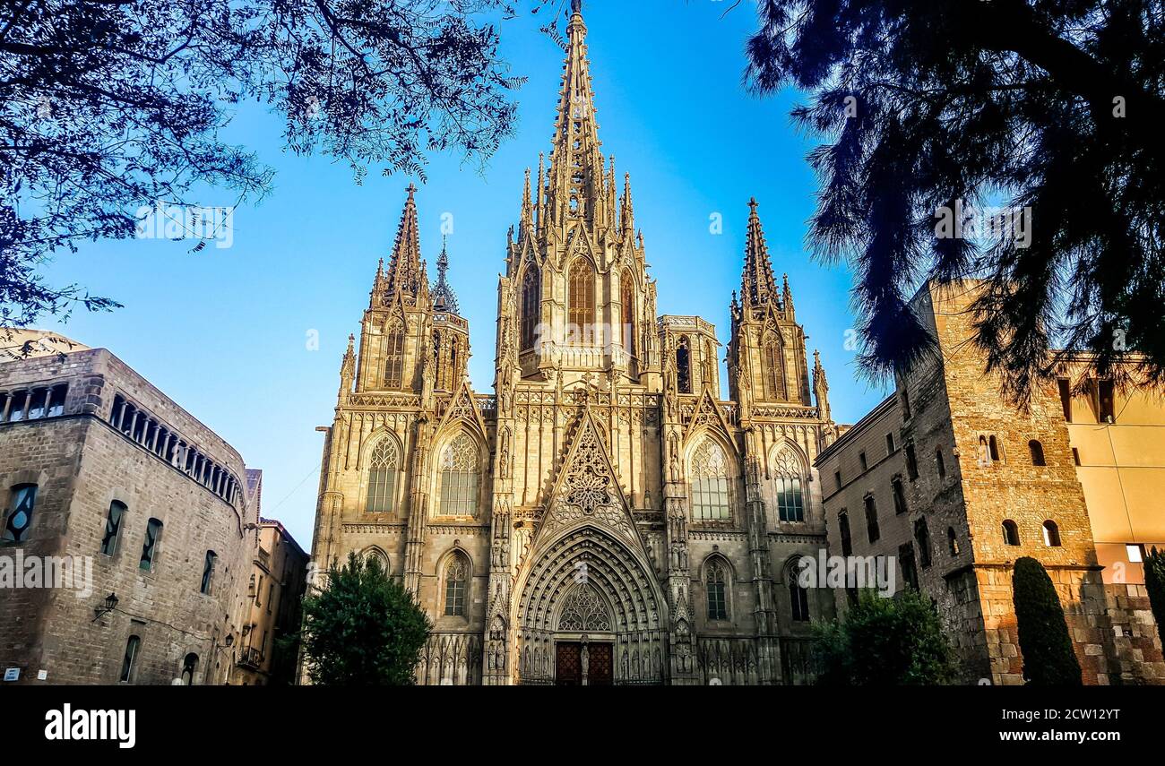 Cathedral of the Holy Cross and Saint Eulalia (Catedral de la Santa Cruz y Santa Eulalia) illuminated by rising sun, Barri Gothic Quarter in Barcelona Stock Photo