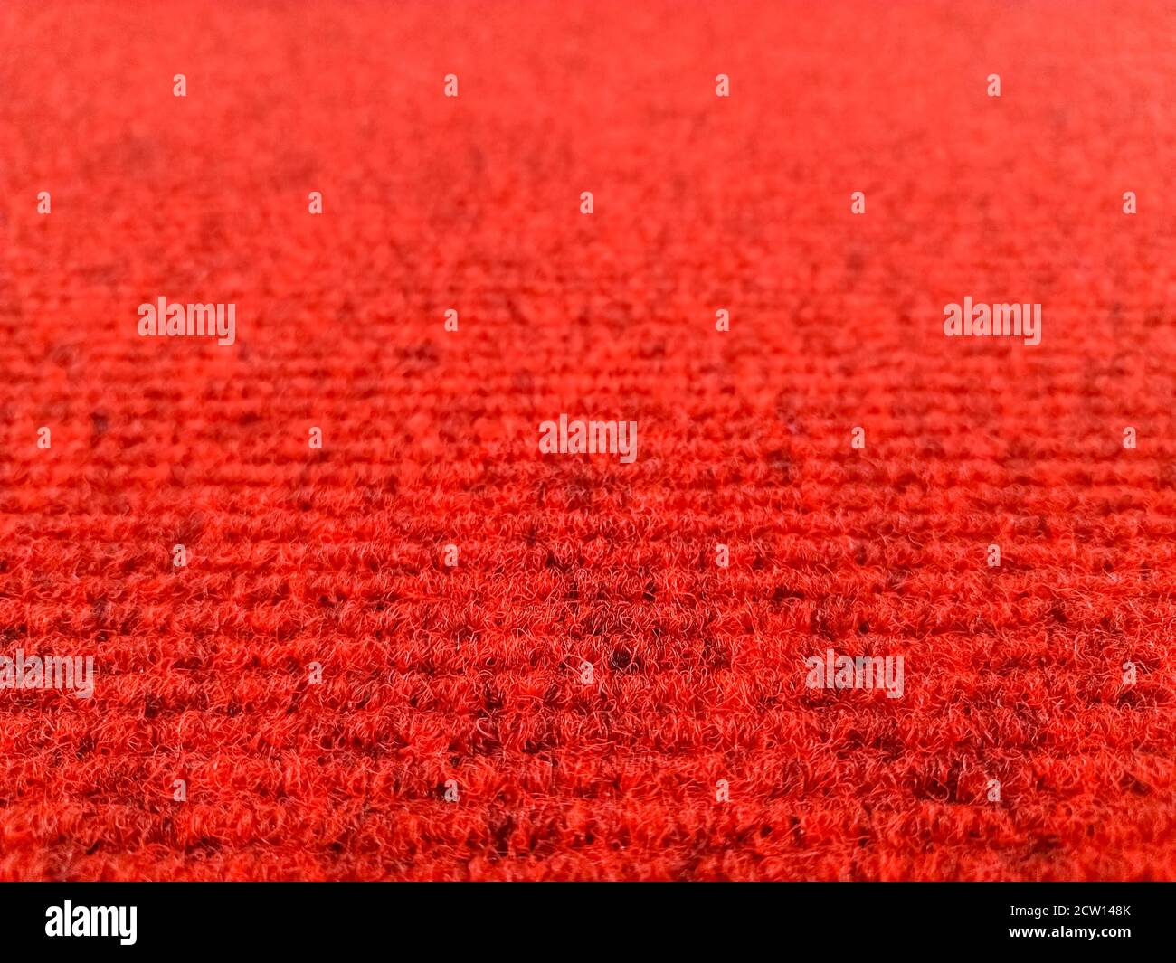 Dark red woolen carpet background with perspective view, selective focus Stock Photo